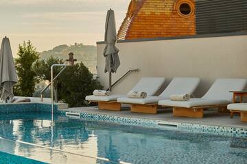 a pool with lounge chairs and umbrellas