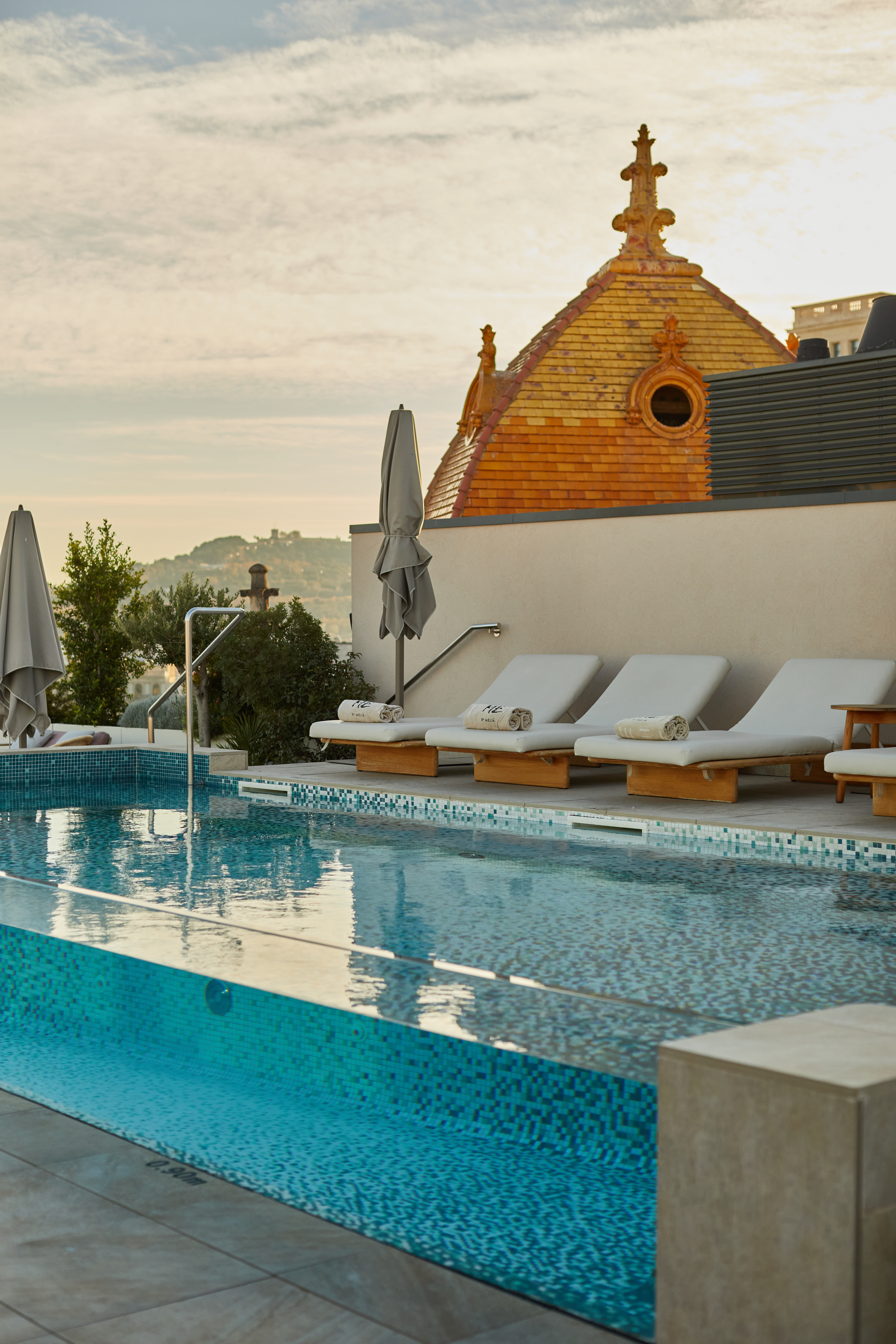 a pool with lounge chairs and umbrellas