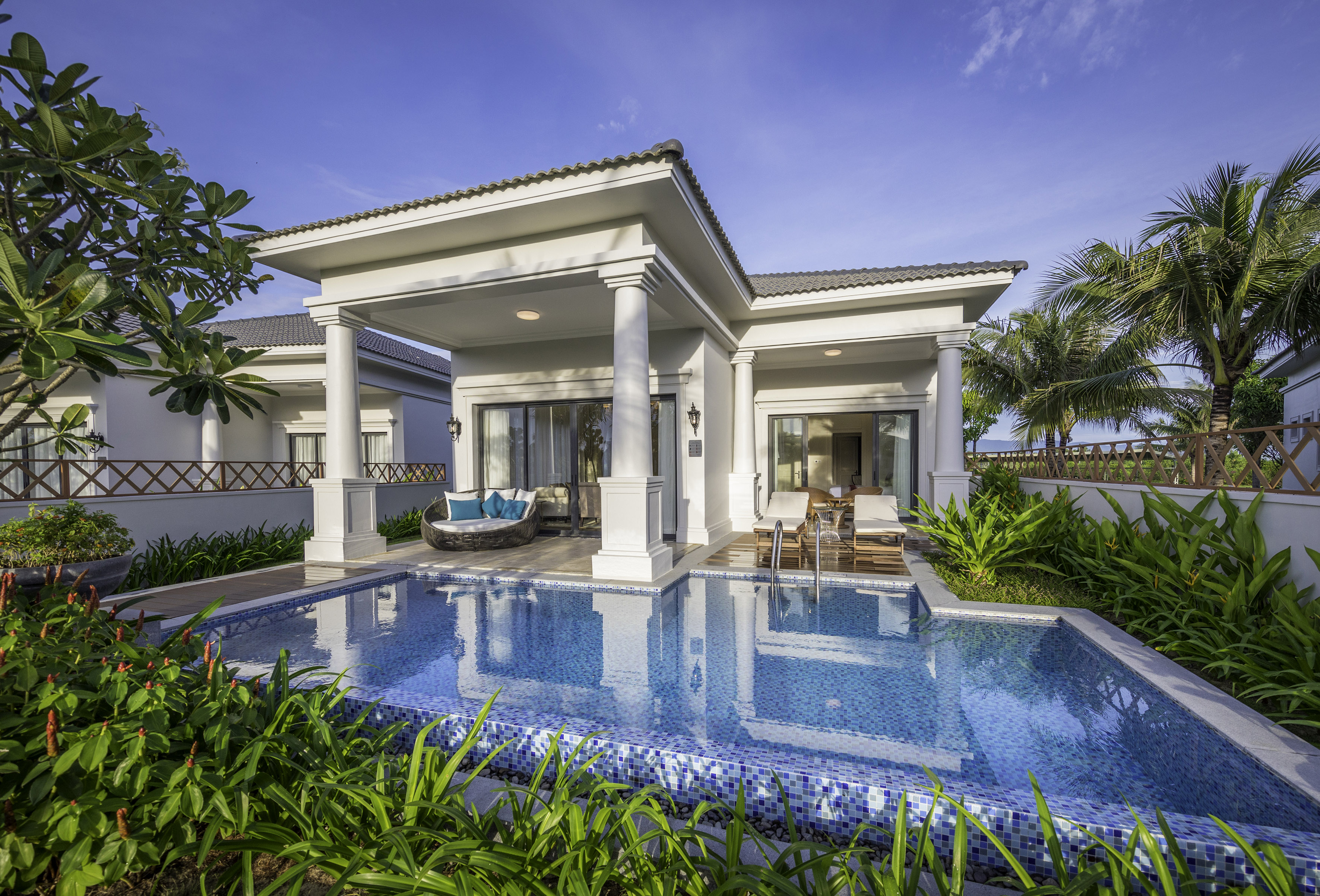 Luxury resort villa with private pool, outdoor lounge, and tropical garden.