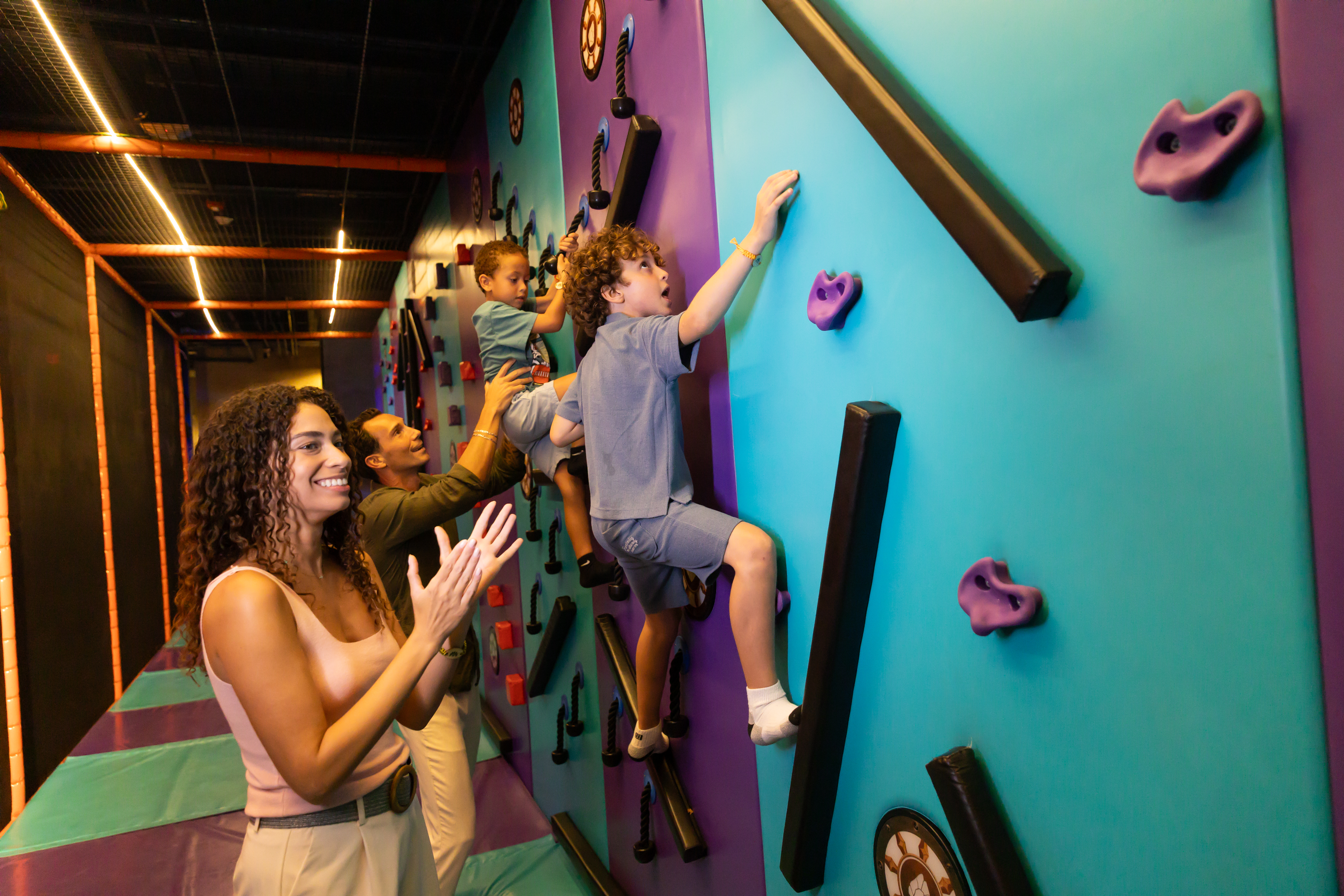 a group of people climbing a wall