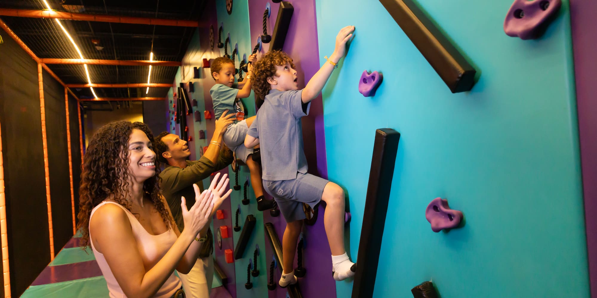 a group of people climbing a wall
