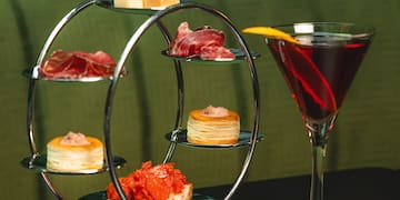 a glass of wine next to a plate of food