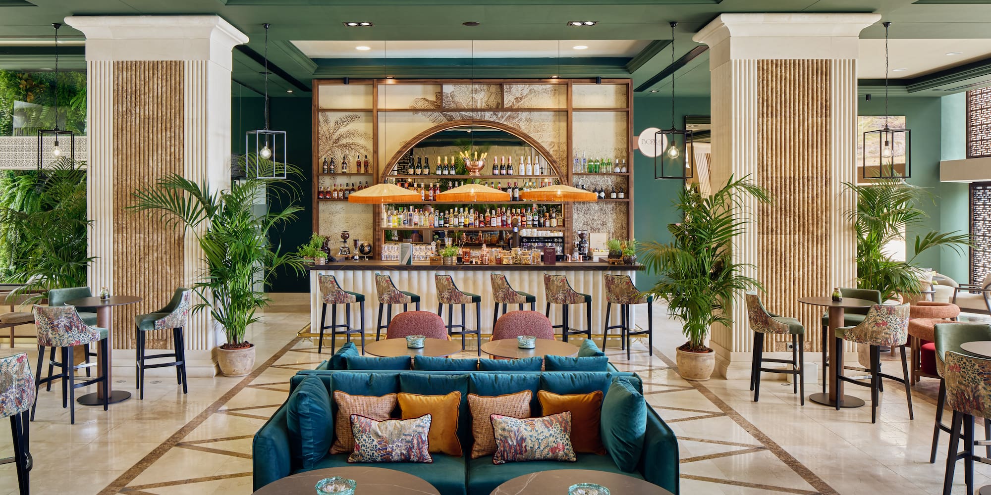 a room with a bar and tables and chairs