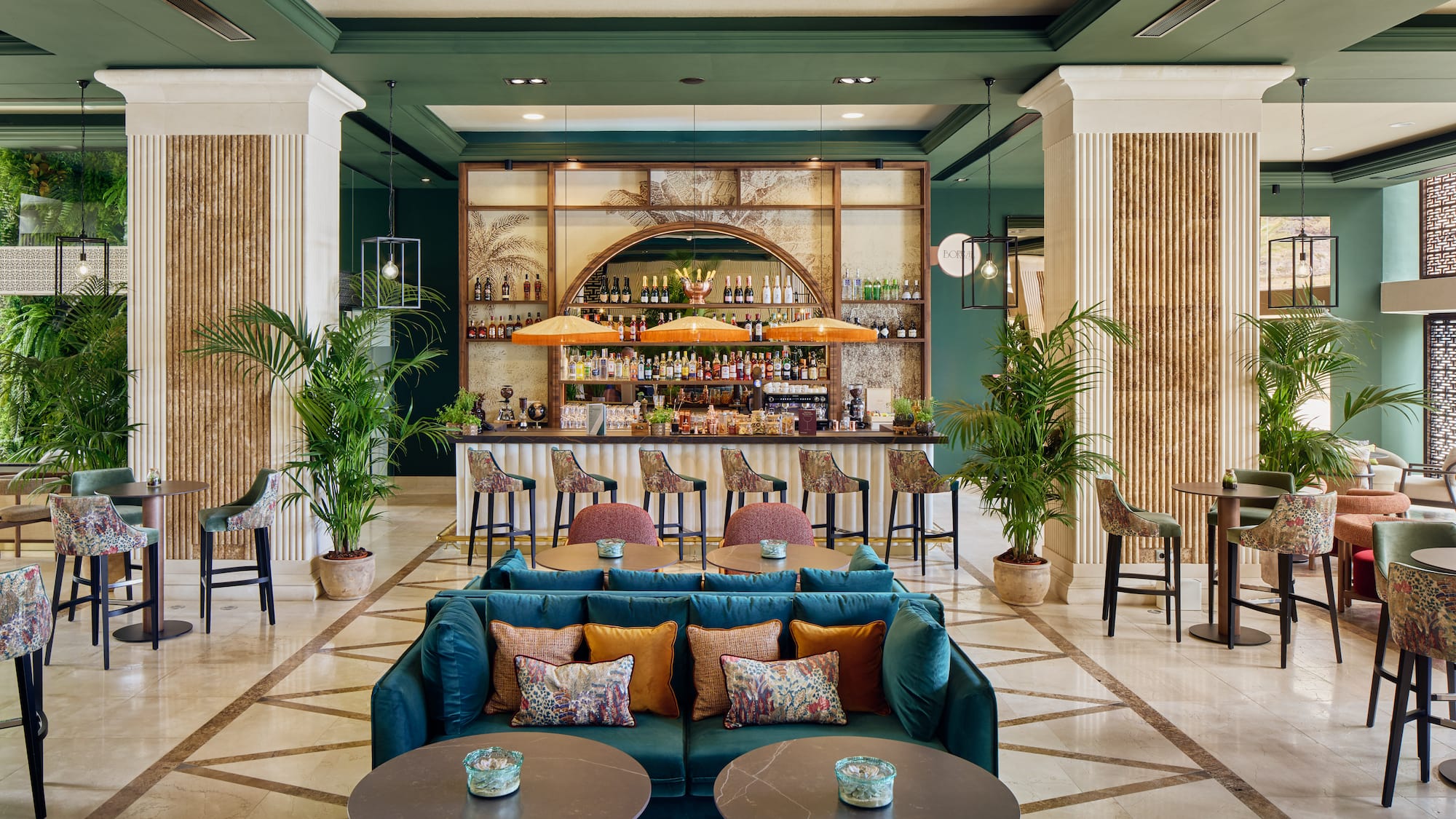 a room with a bar and tables and chairs