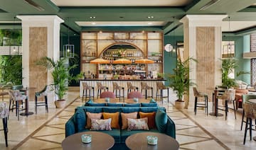 a room with a bar and tables and chairs