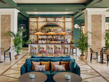 a room with a bar and tables and chairs