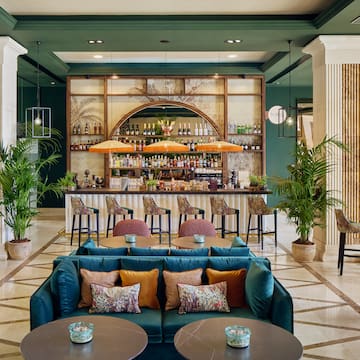 a room with a bar and tables and chairs