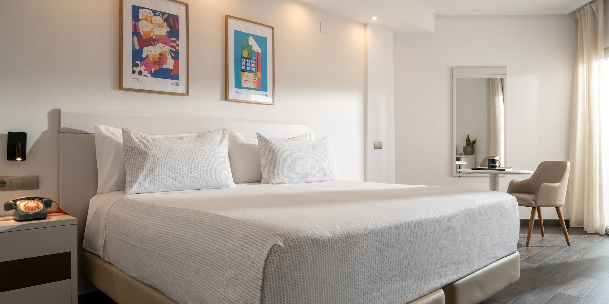 a bed with white sheets and pillows