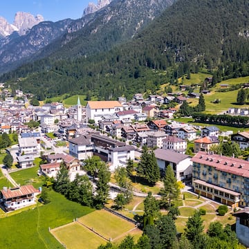 a city with many buildings and trees in a valley
