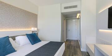 a bedroom with a bed and a door.