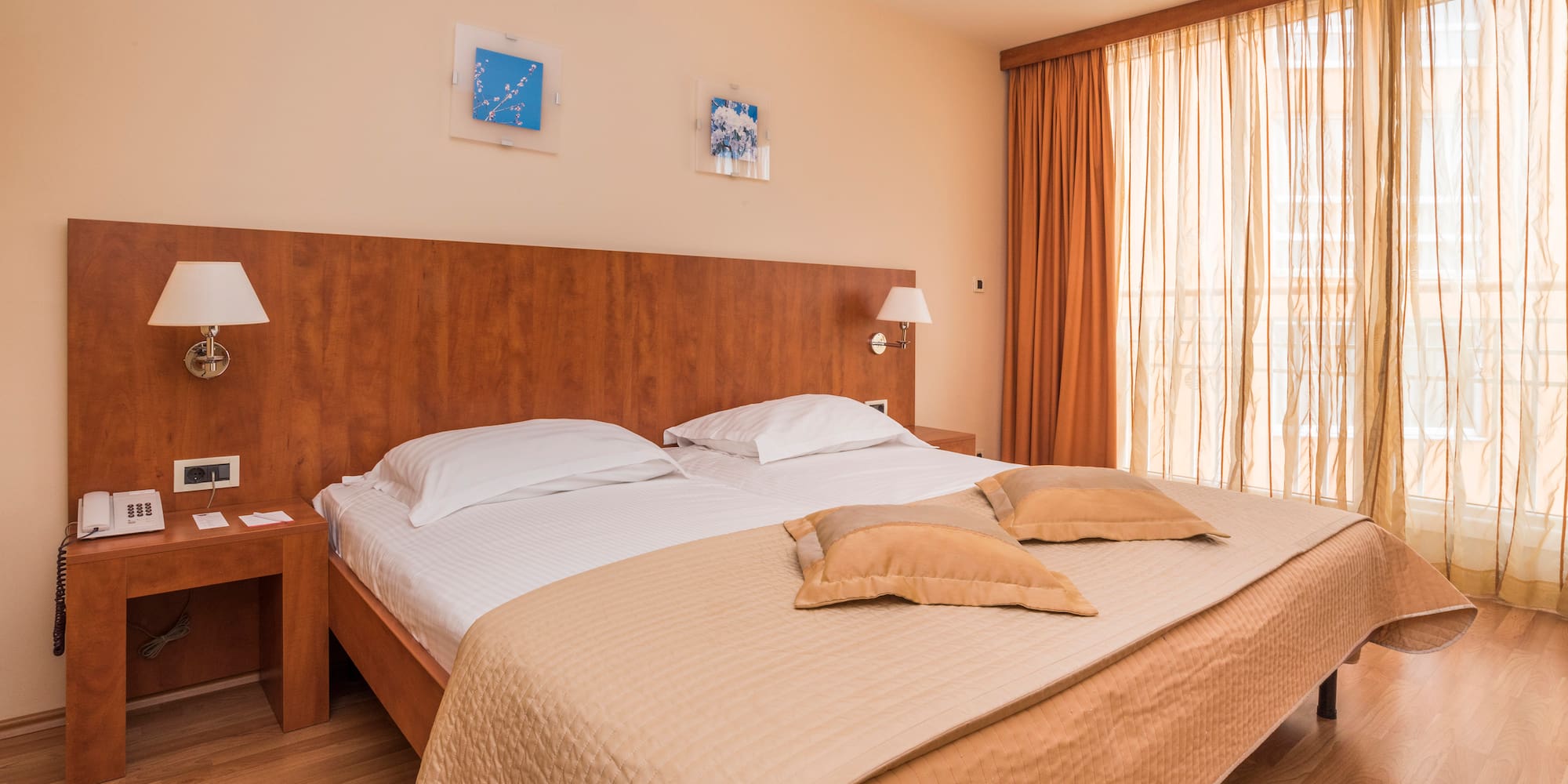 a bed with pillows and lamps in a room