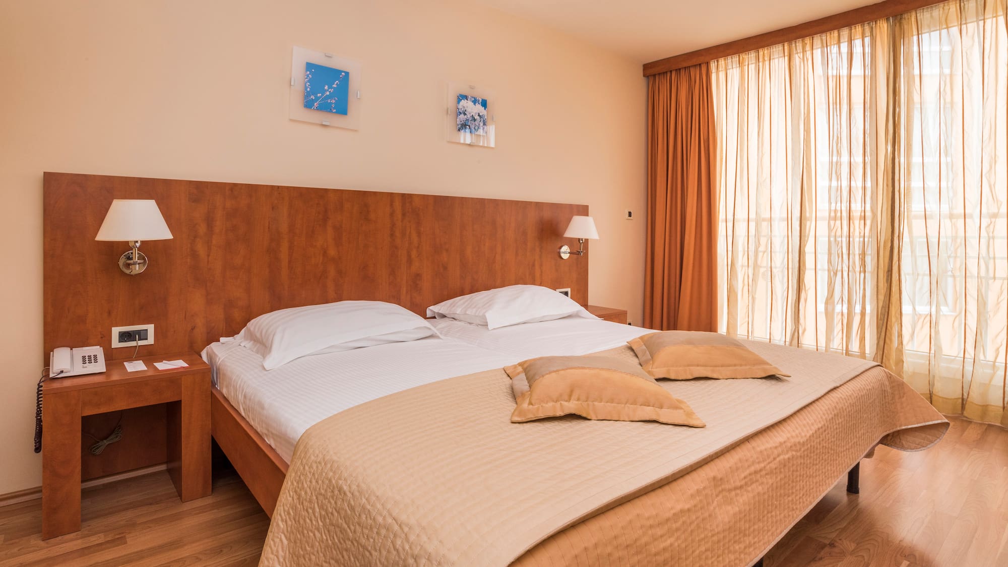 a bed with pillows and lamps in a room