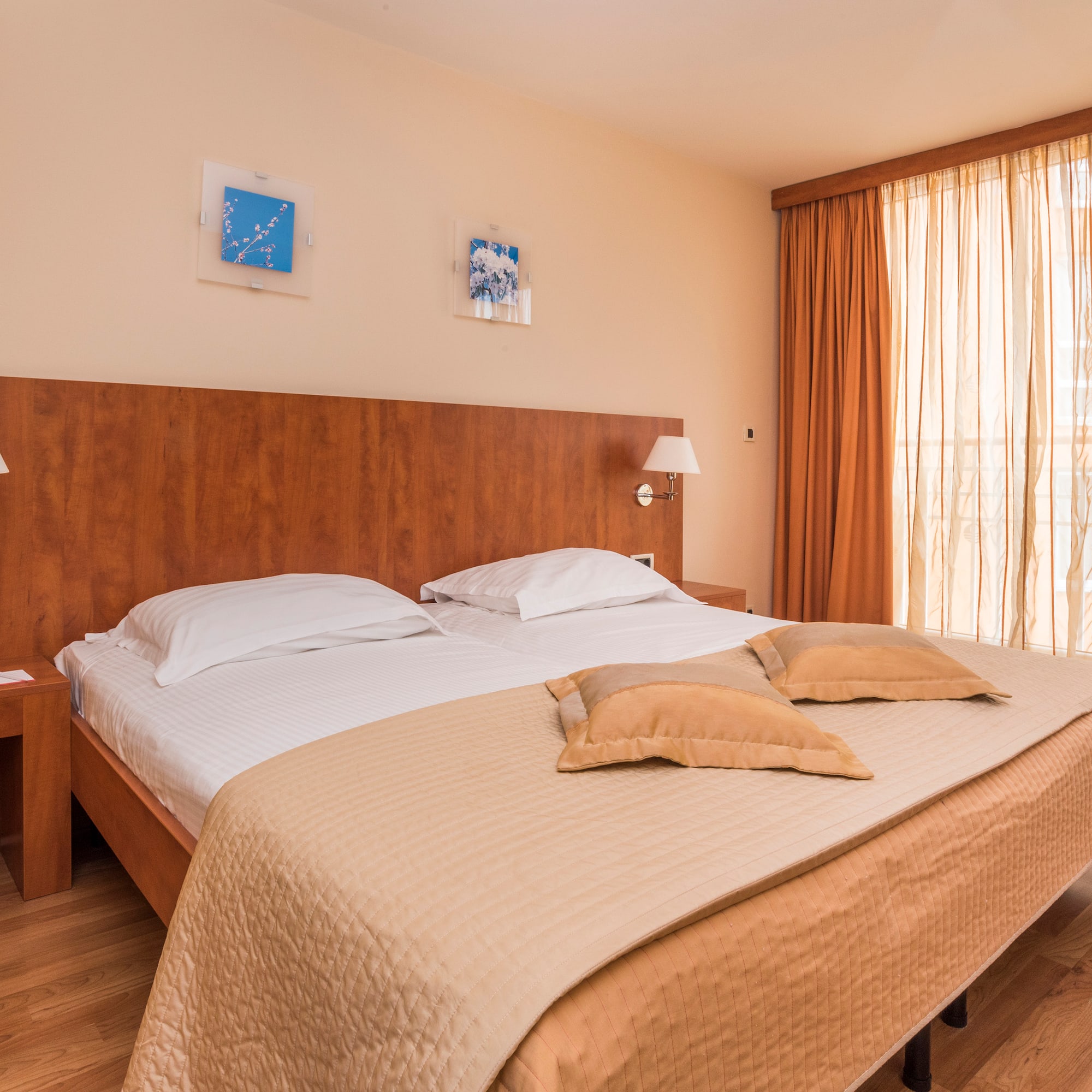 a bed with pillows and lamps in a room