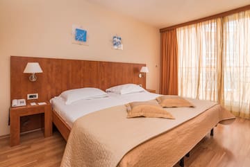 a bed with pillows and lamps in a room