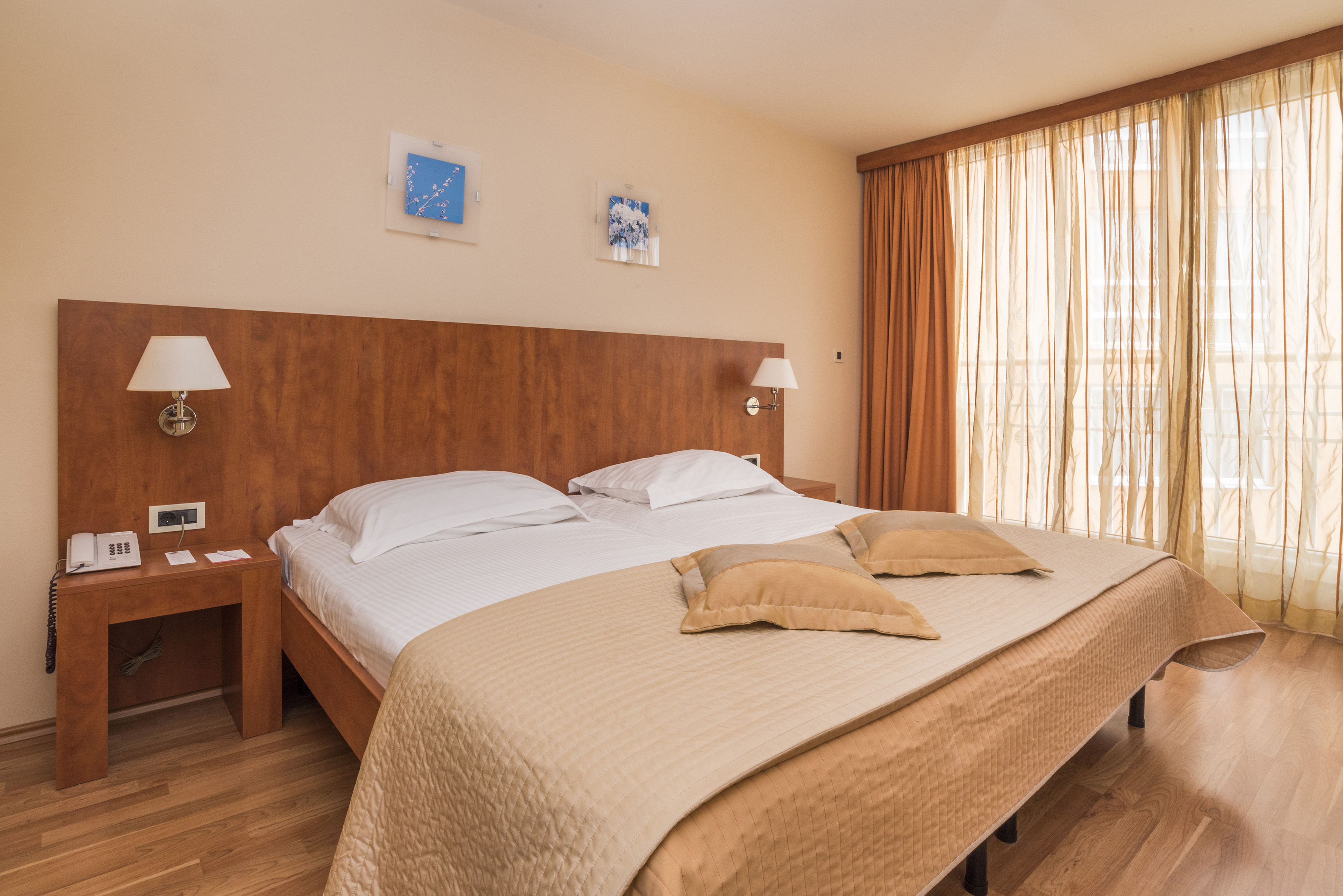 a bed with pillows and lamps in a room