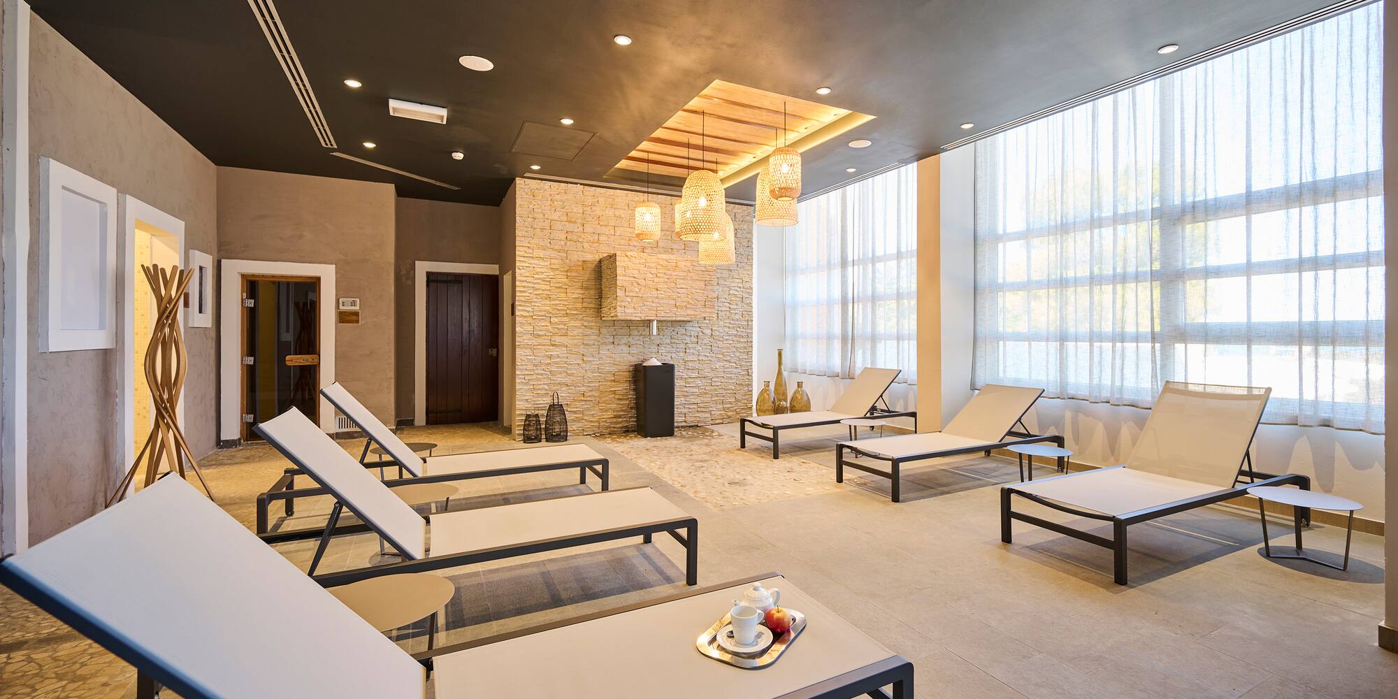 a room with lounge chairs and a fireplace