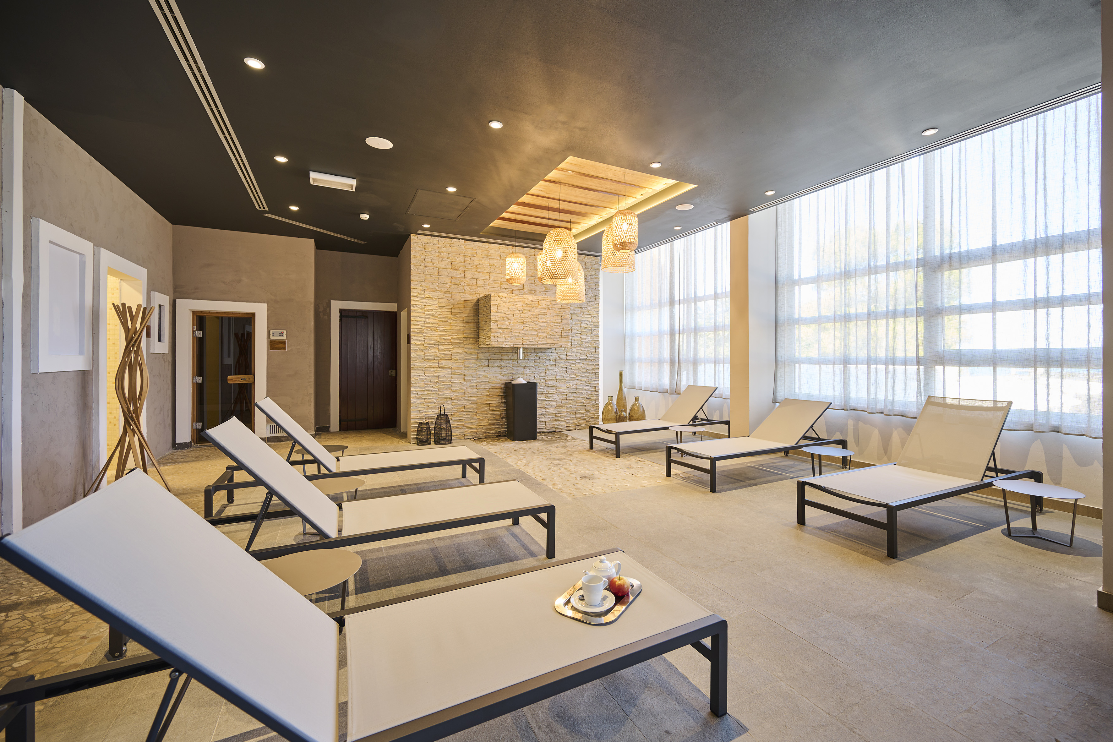 a room with lounge chairs and a fireplace