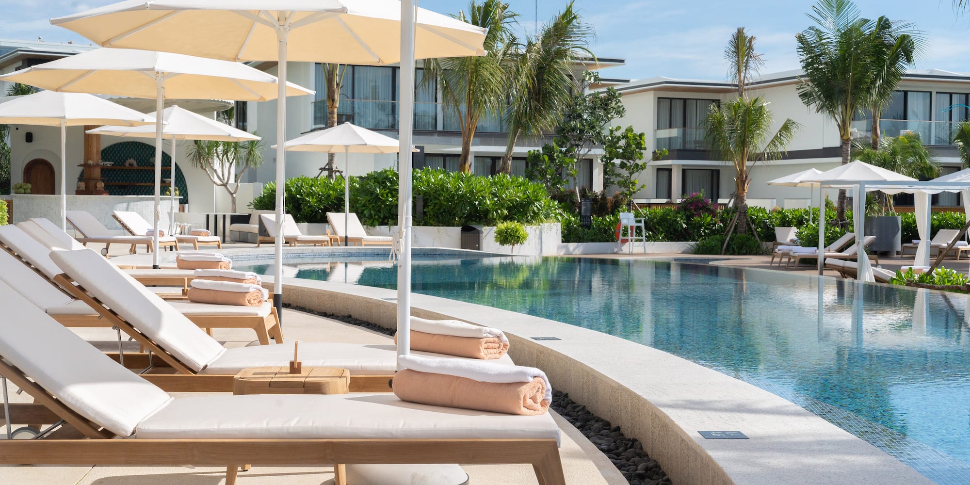 a pool with lounge chairs and umbrellas