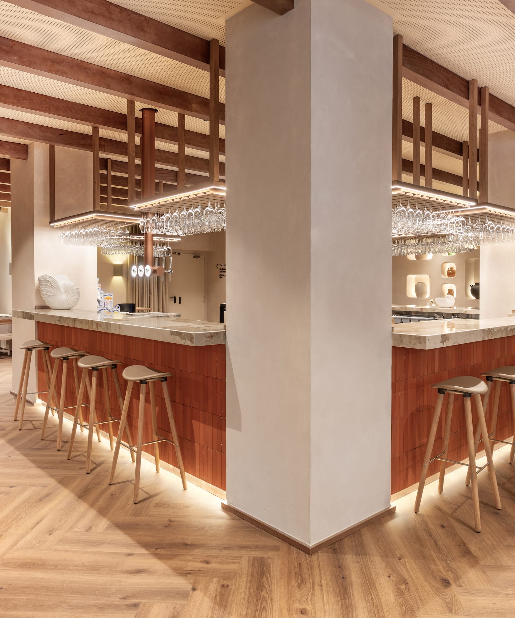 a bar with stools and chandeliers