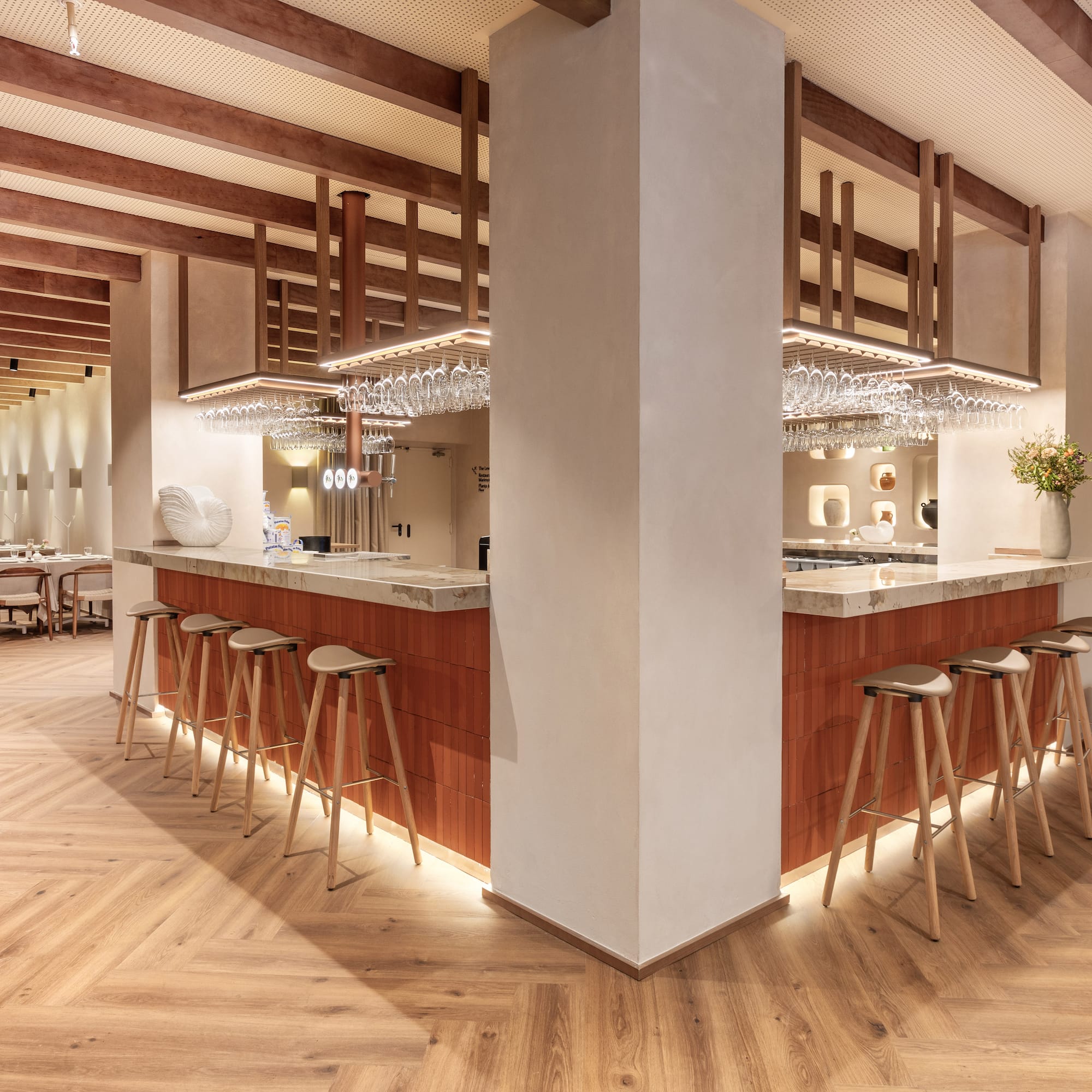 a bar with stools and chandeliers
