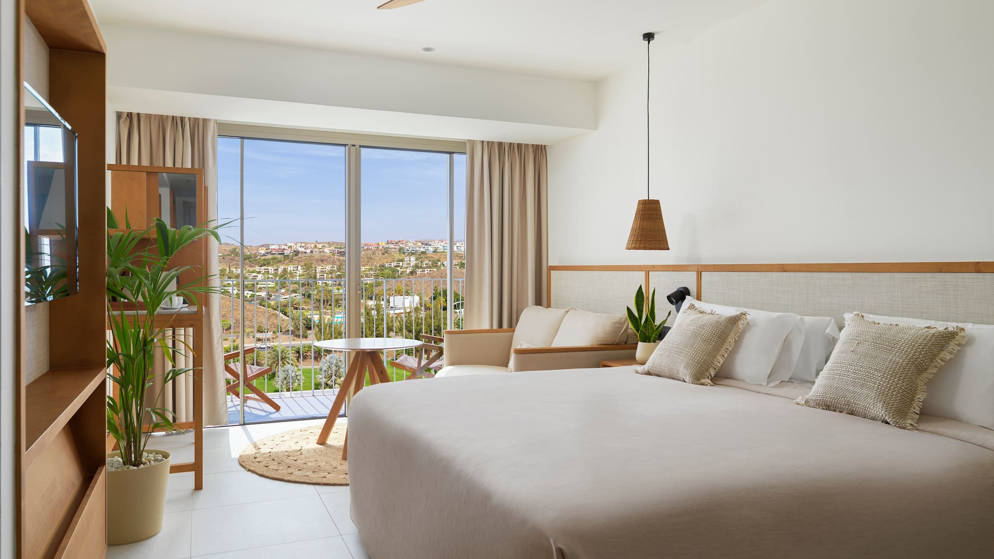 a bedroom with a large bed and a ceiling fan