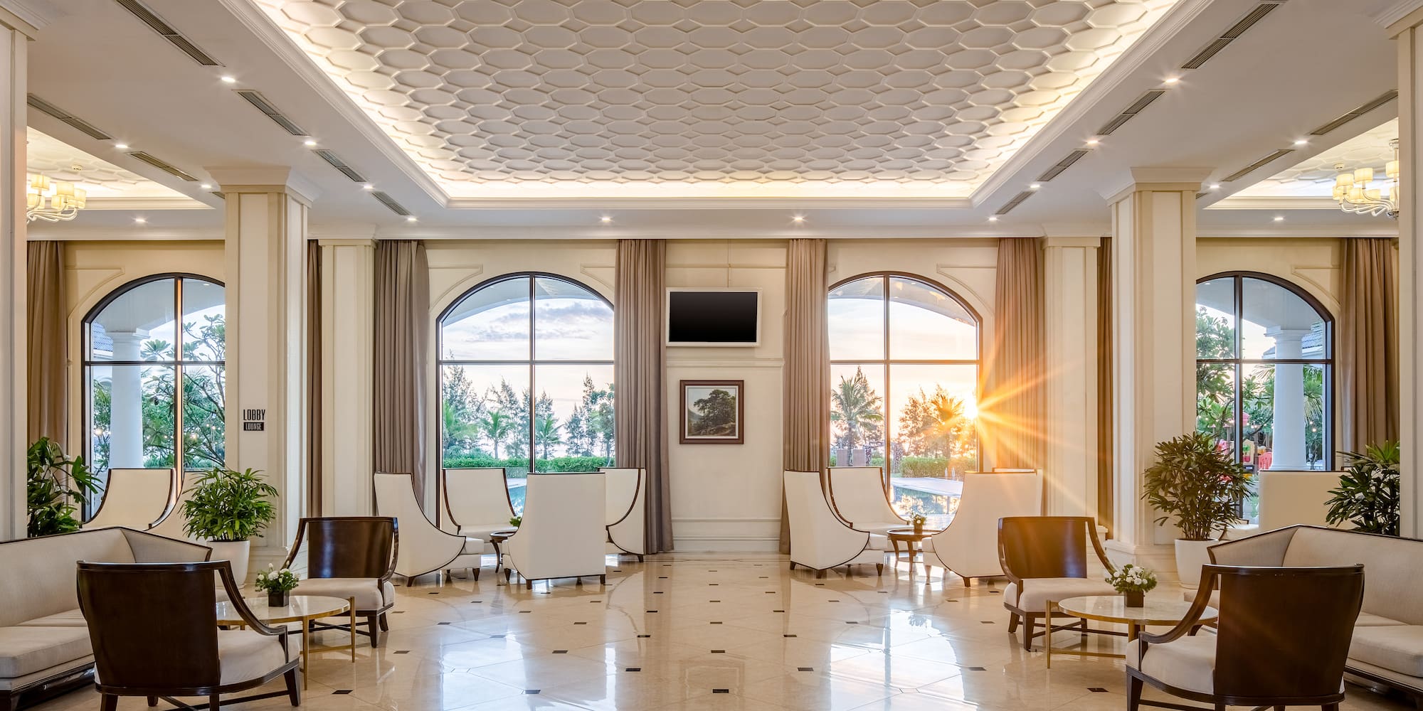 a room with white chairs and a tiled floor