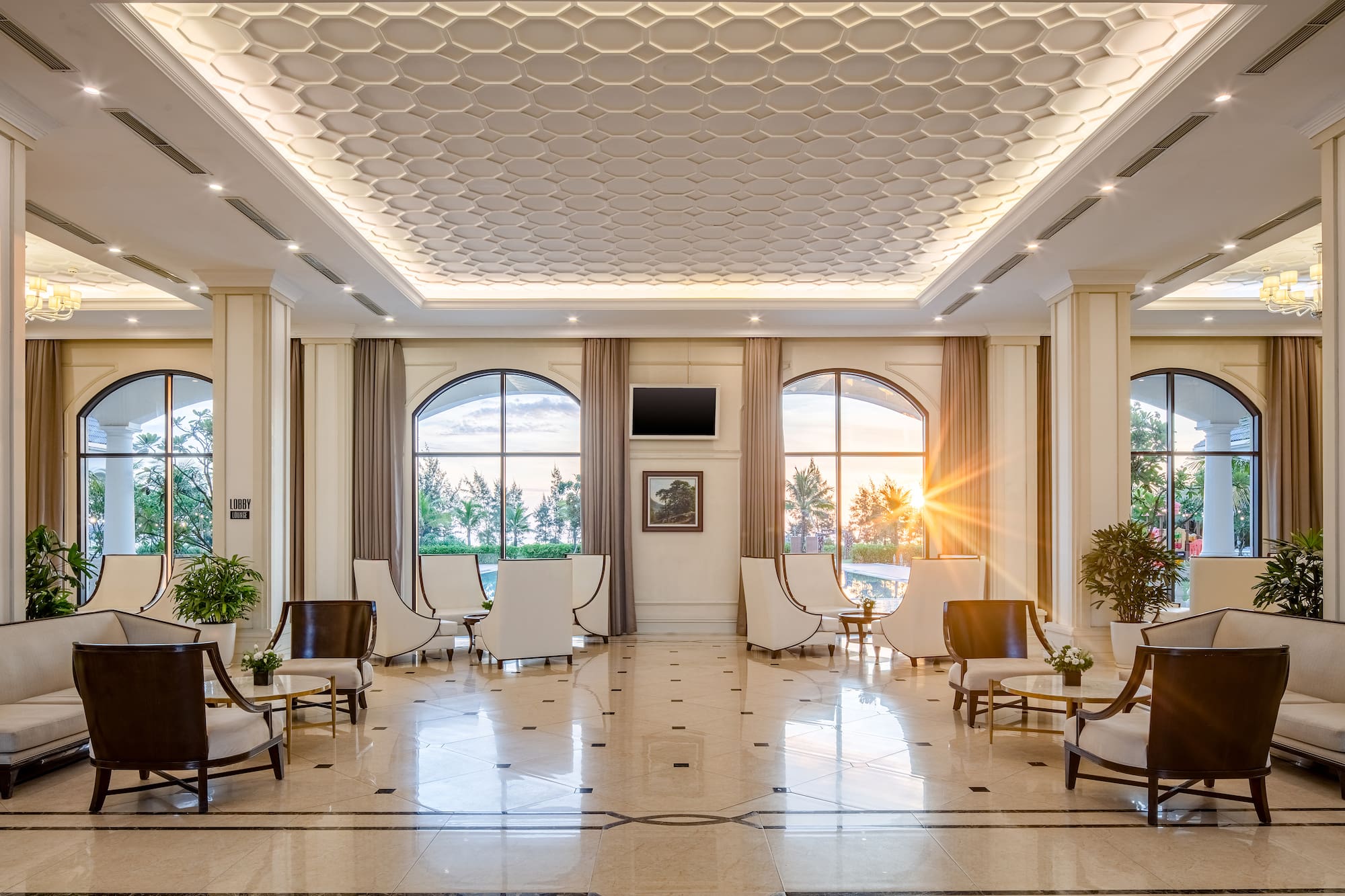 a room with white chairs and a tiled floor