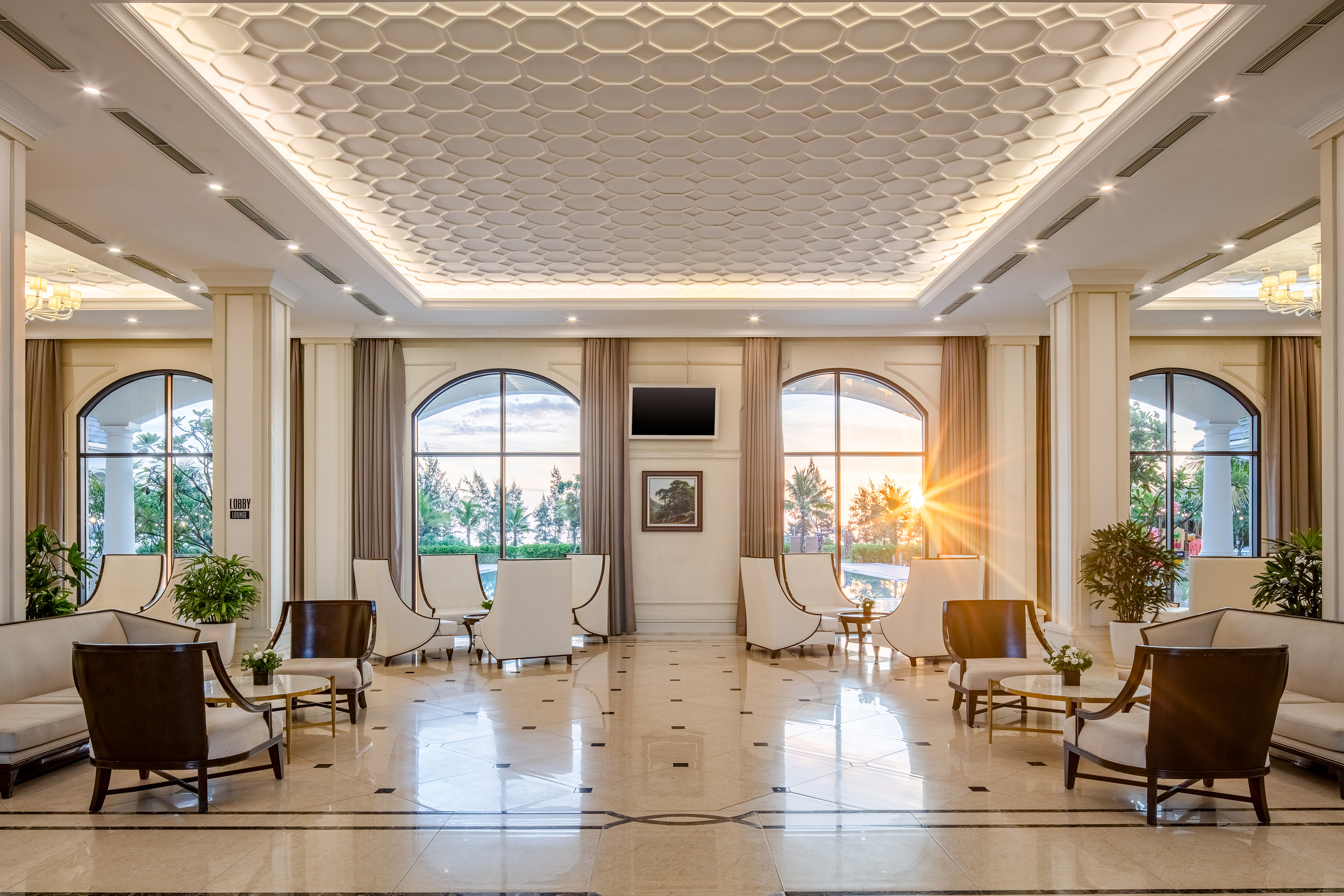 a room with white chairs and a tiled floor
