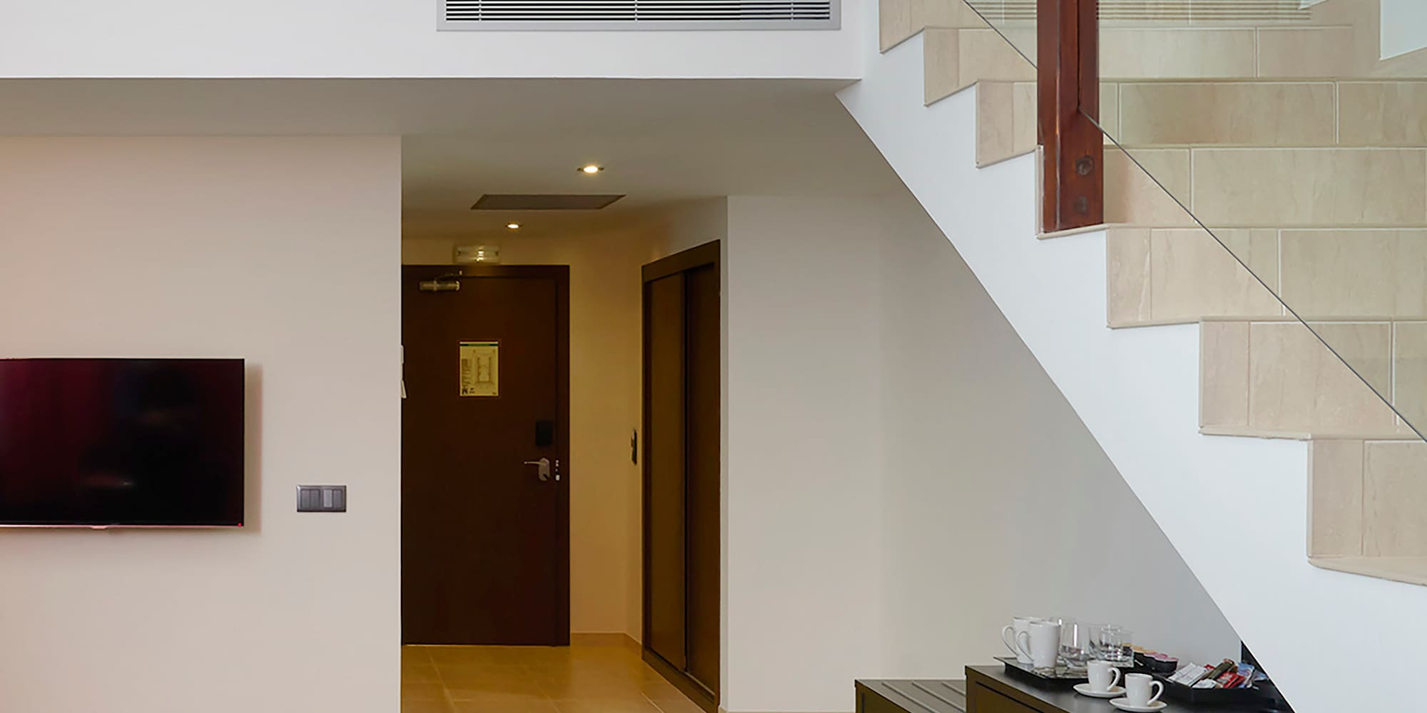 a living room with a couch and stairs