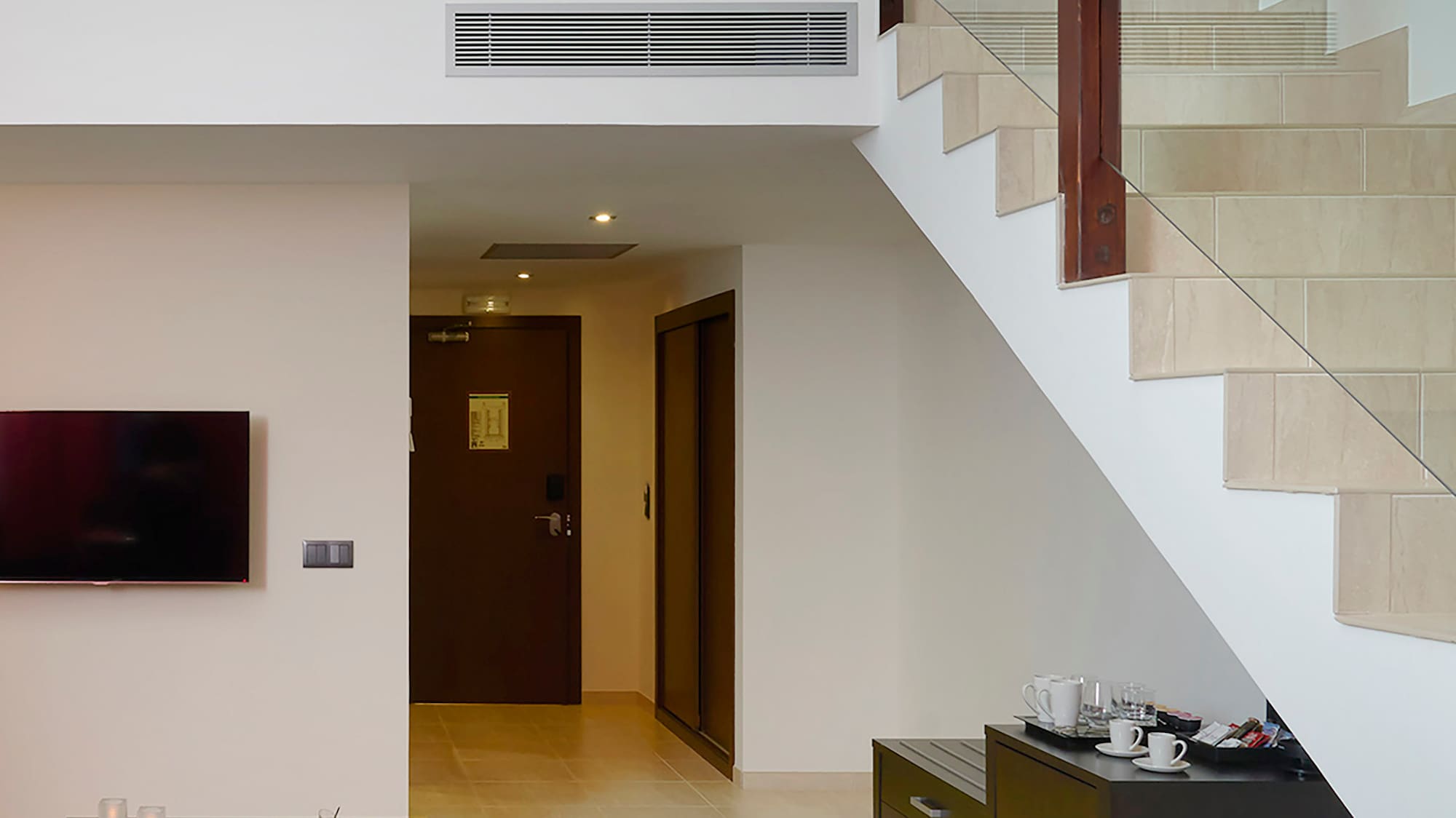 a living room with a couch and stairs