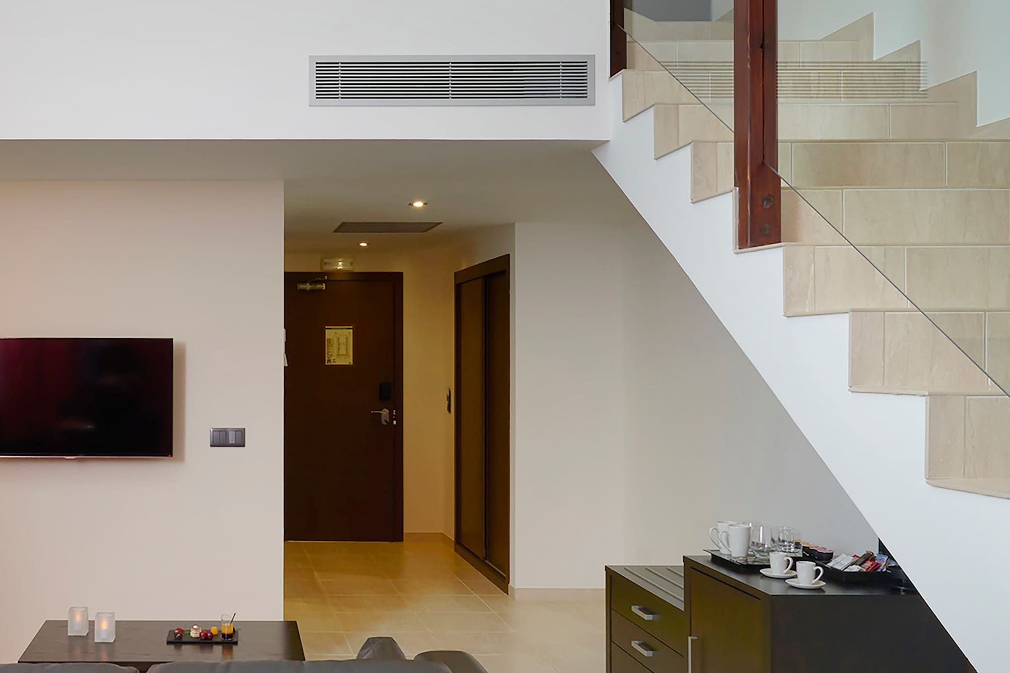 a living room with a couch and stairs