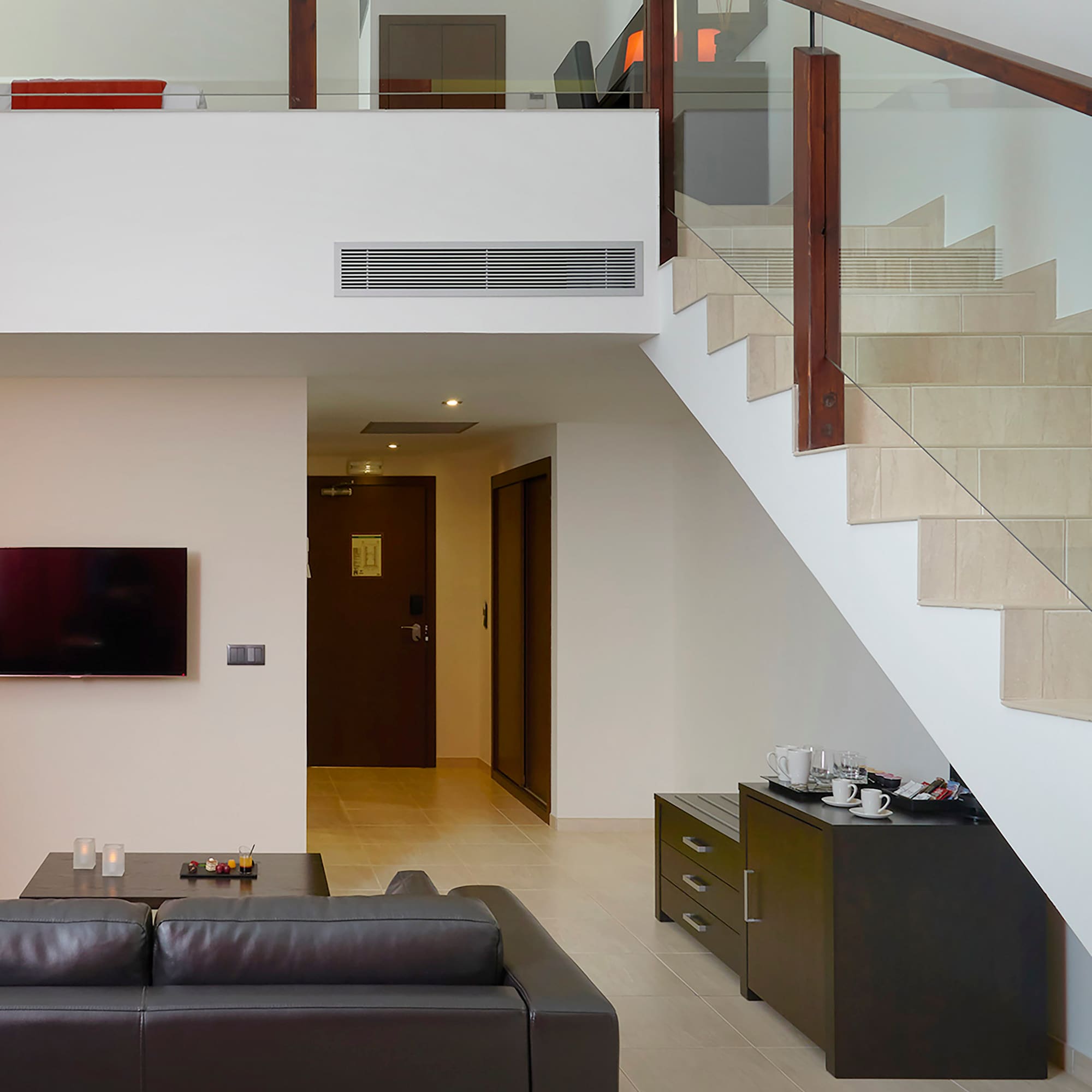 a living room with a couch and stairs