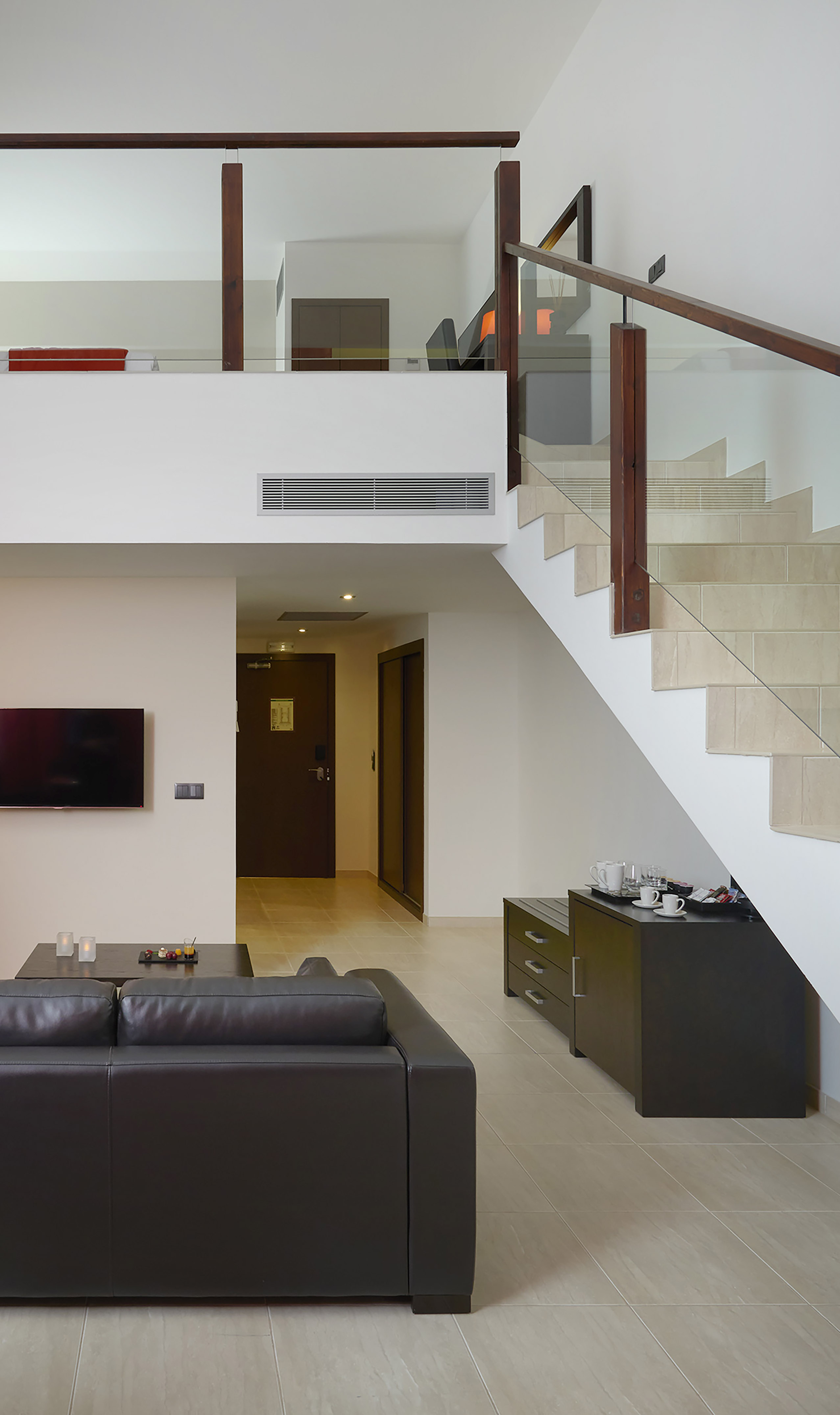 a living room with a couch and stairs