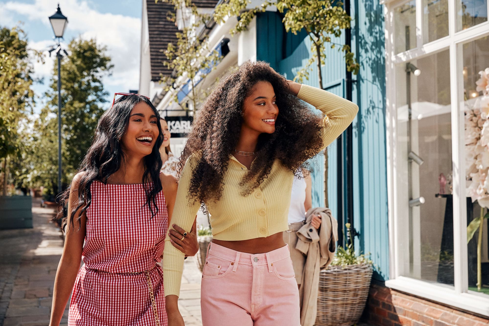 two women walking down a sidewalk