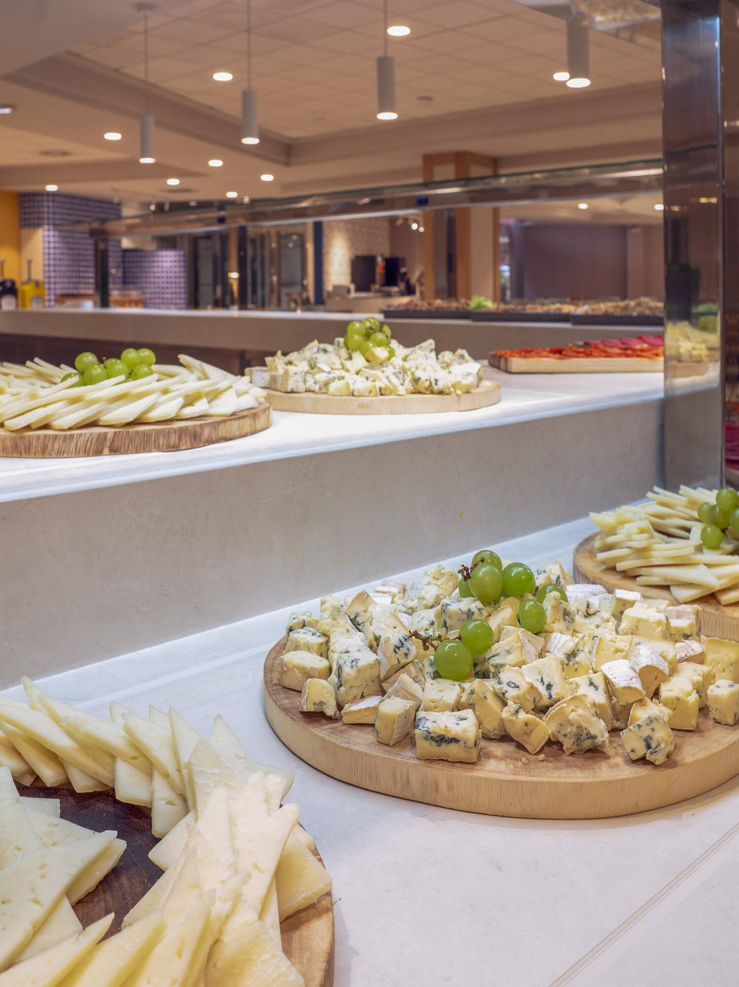a group of cheese platters on a counter