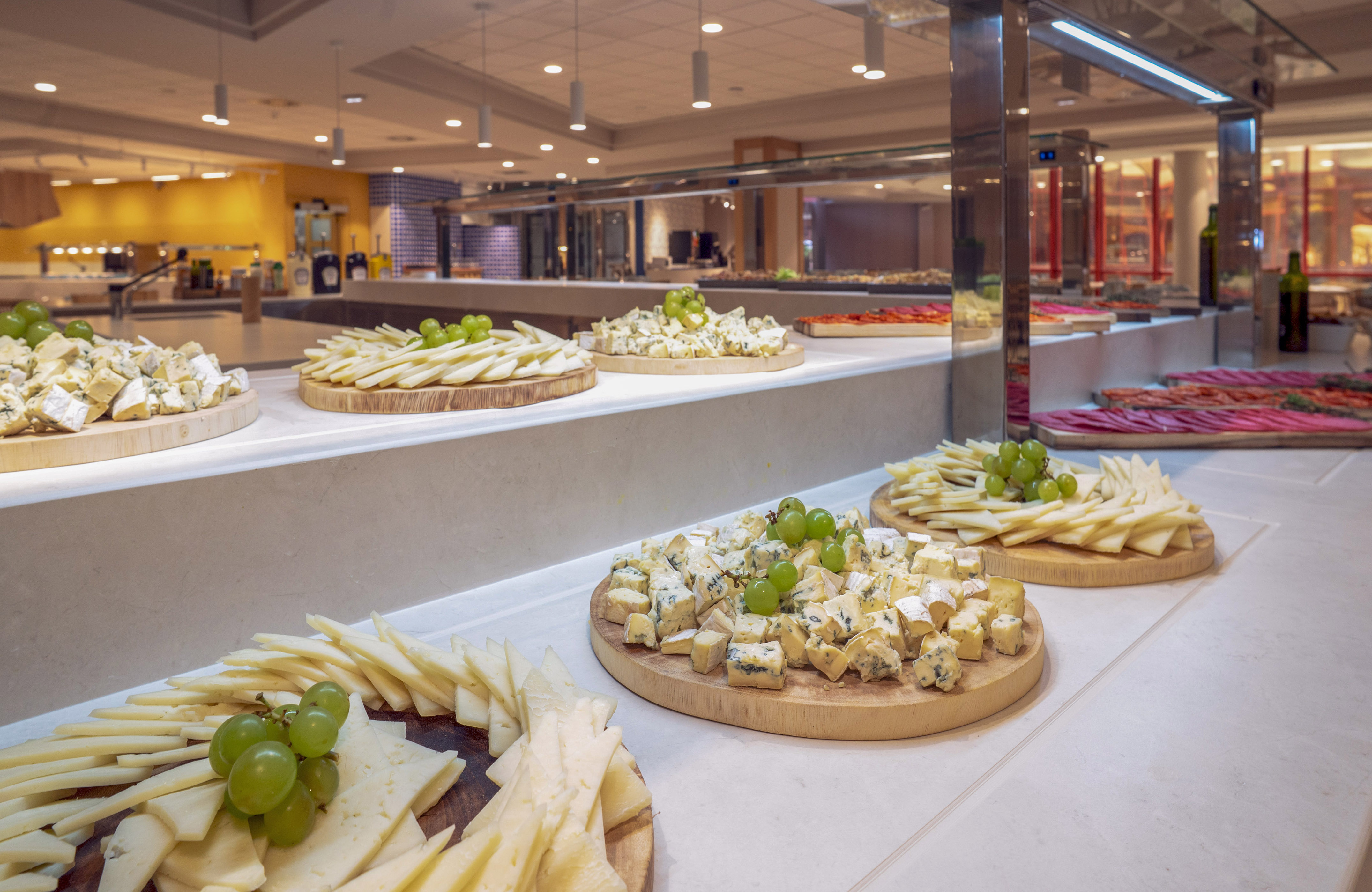a group of cheese platters on a counter