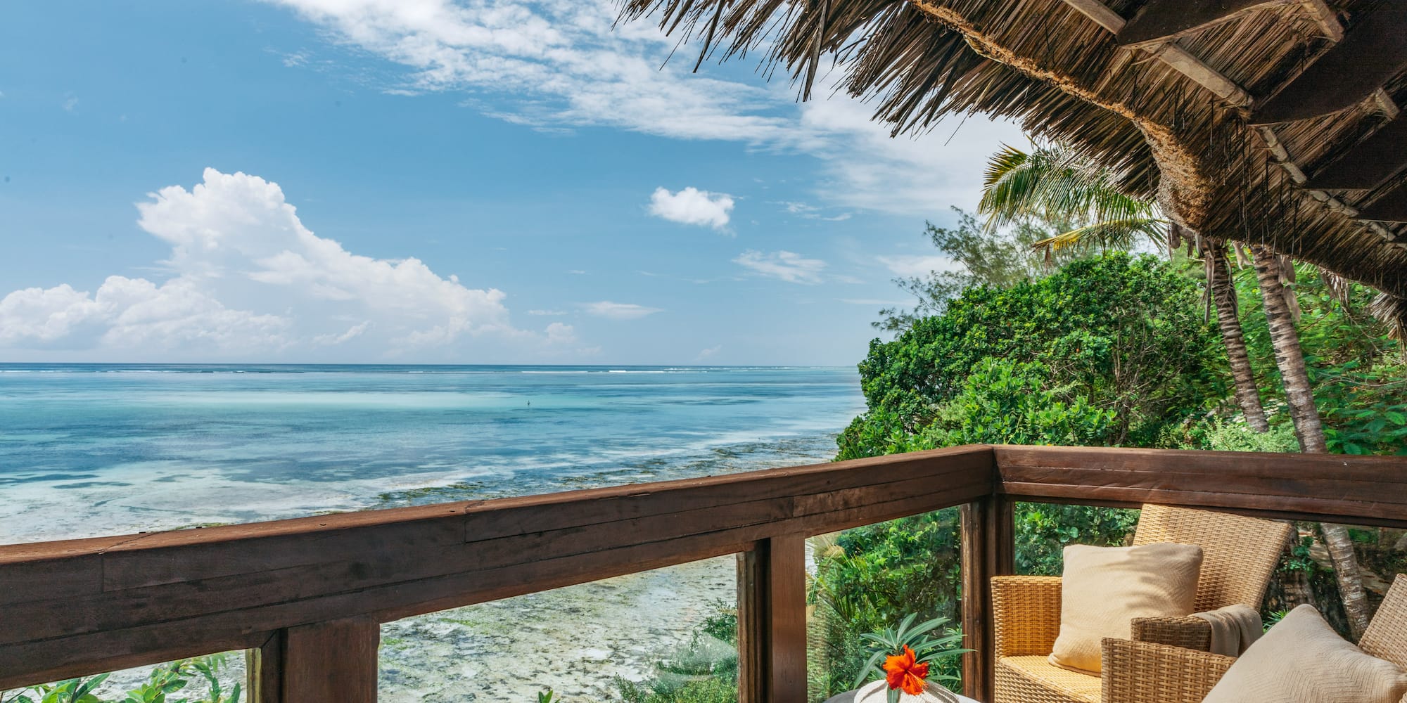 a deck with a view of the ocean and a chair