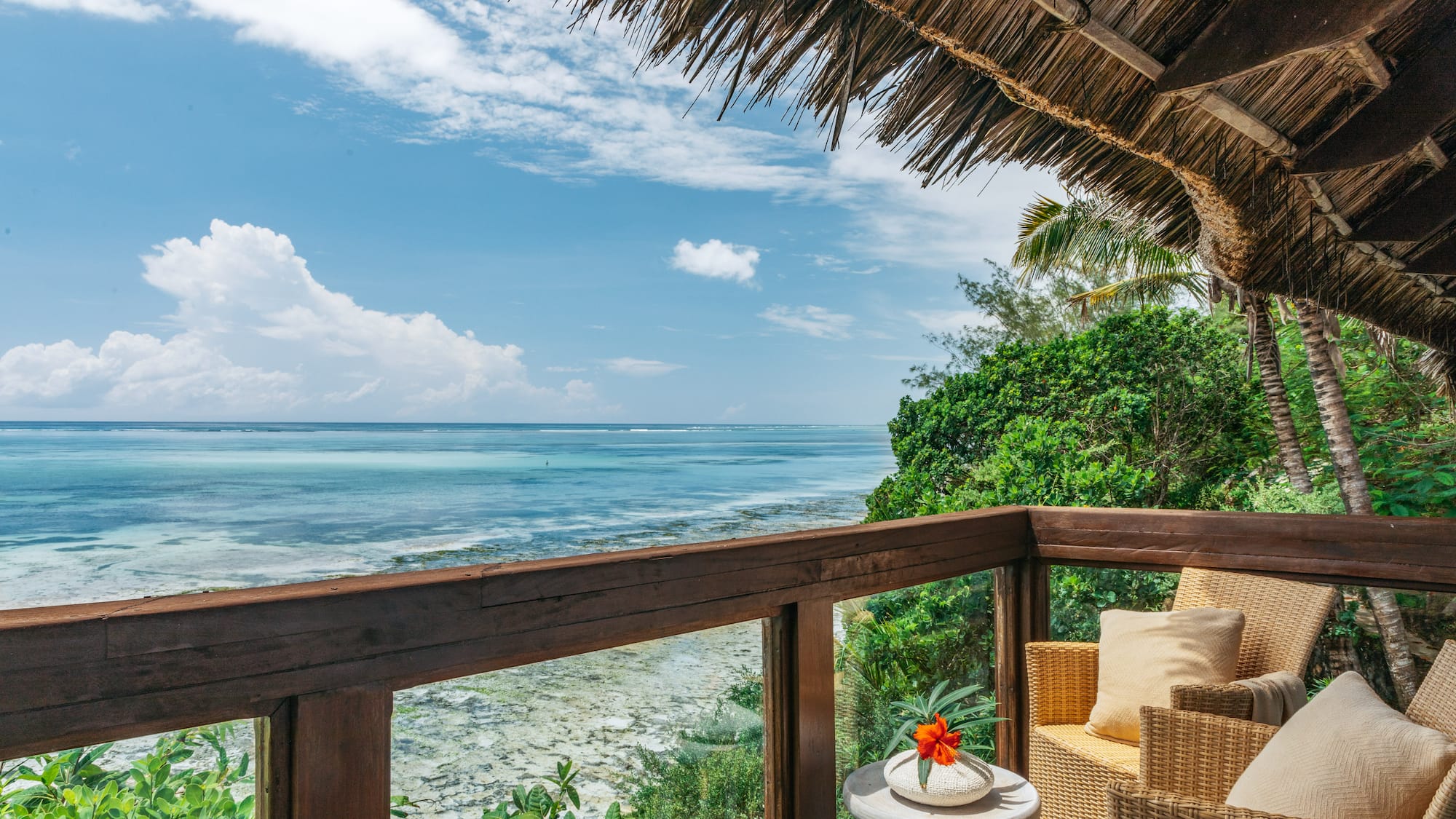 a deck with a view of the ocean and a chair