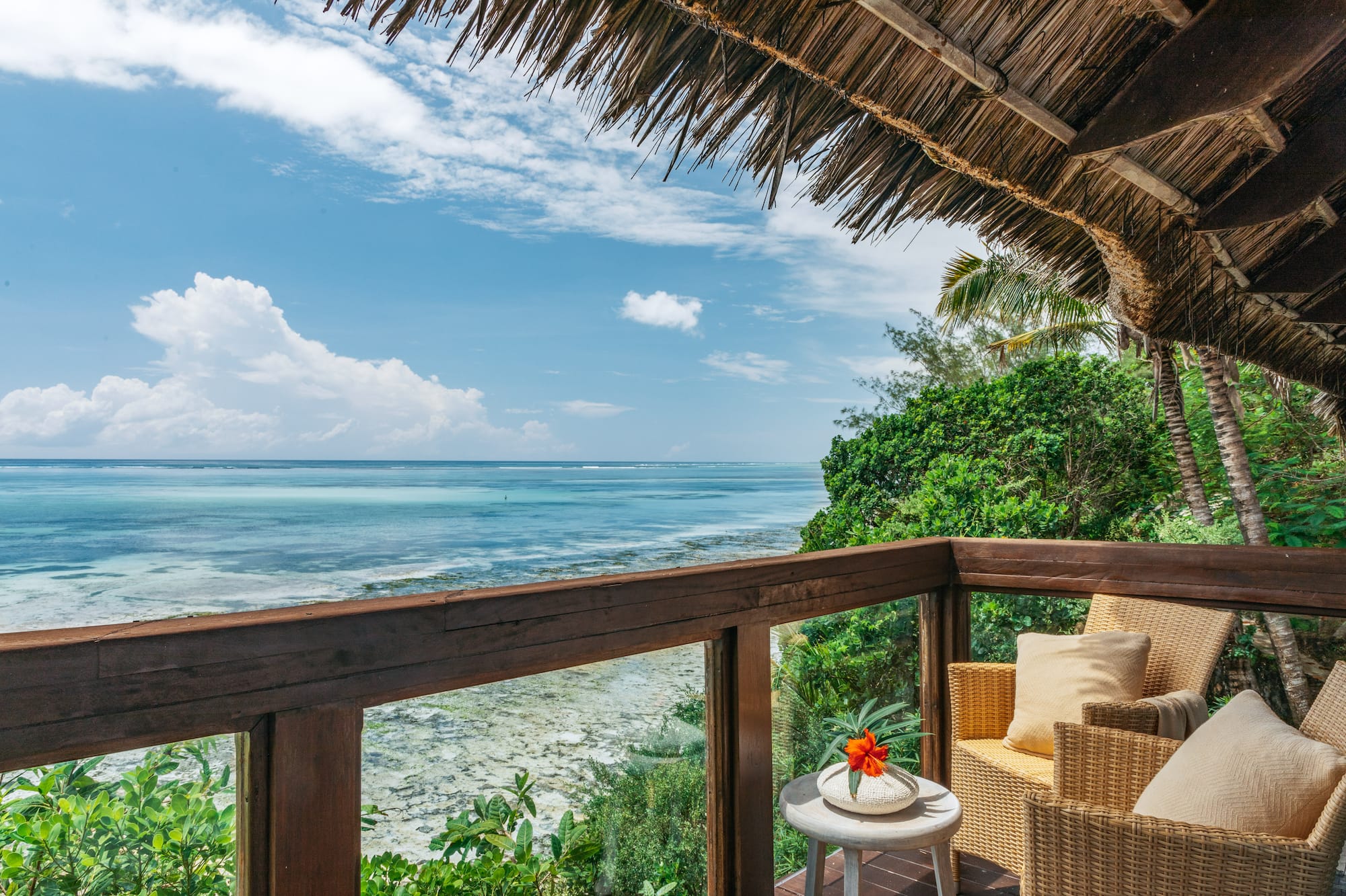 a deck with a view of the ocean and a chair