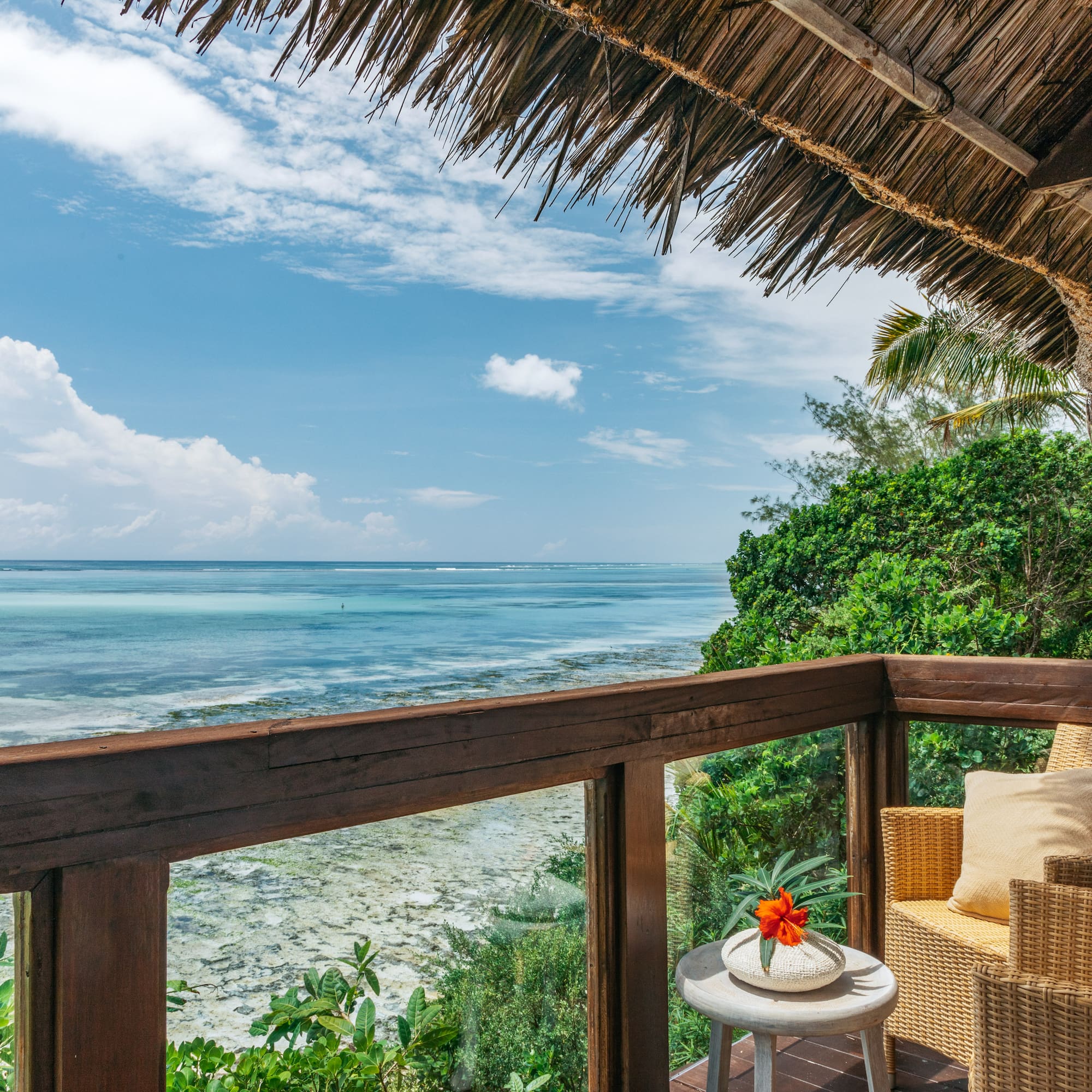 a deck with a view of the ocean and a chair