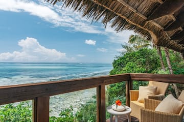 a deck with a view of the ocean and a chair