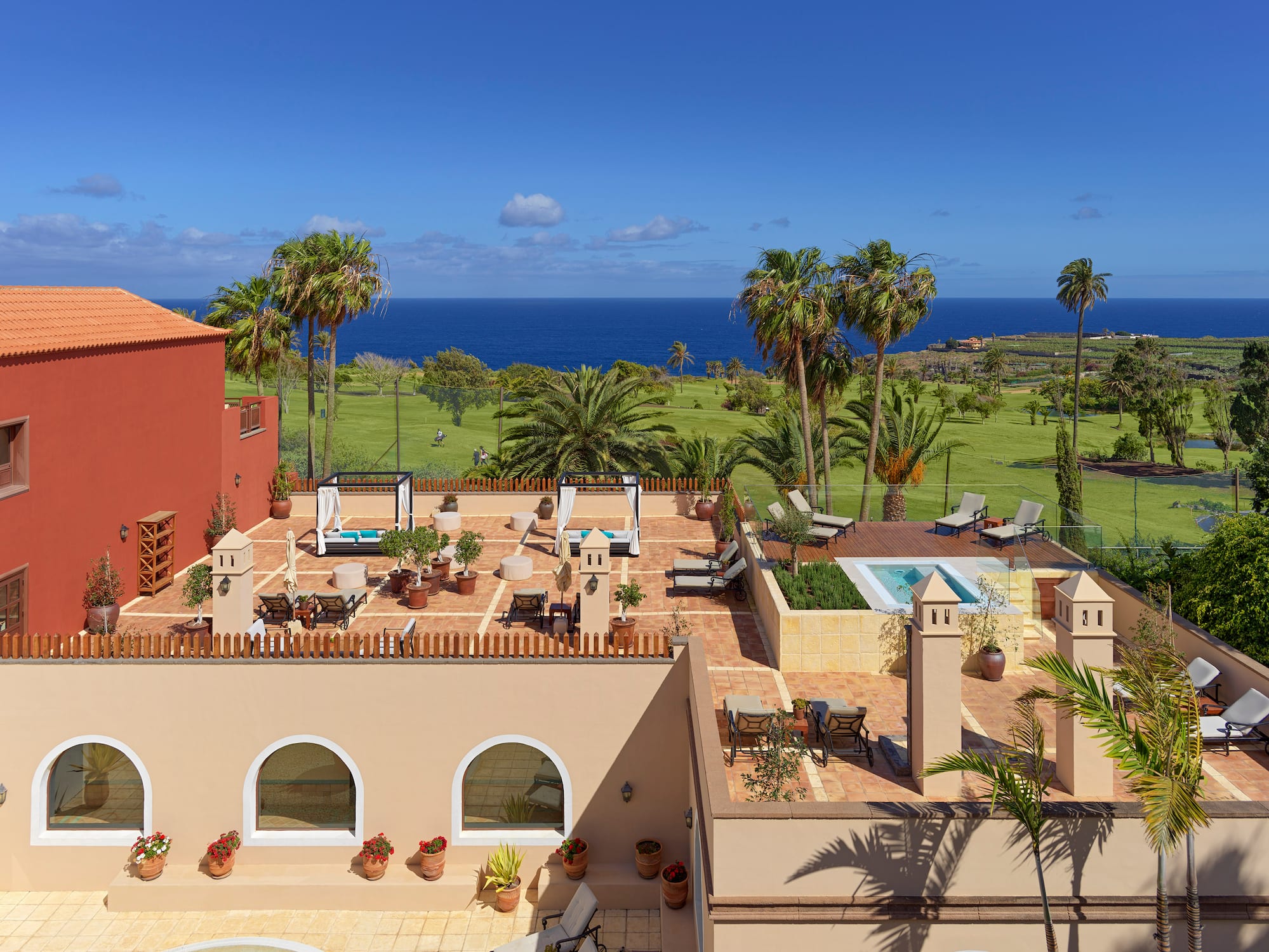 a building with a pool and palm trees