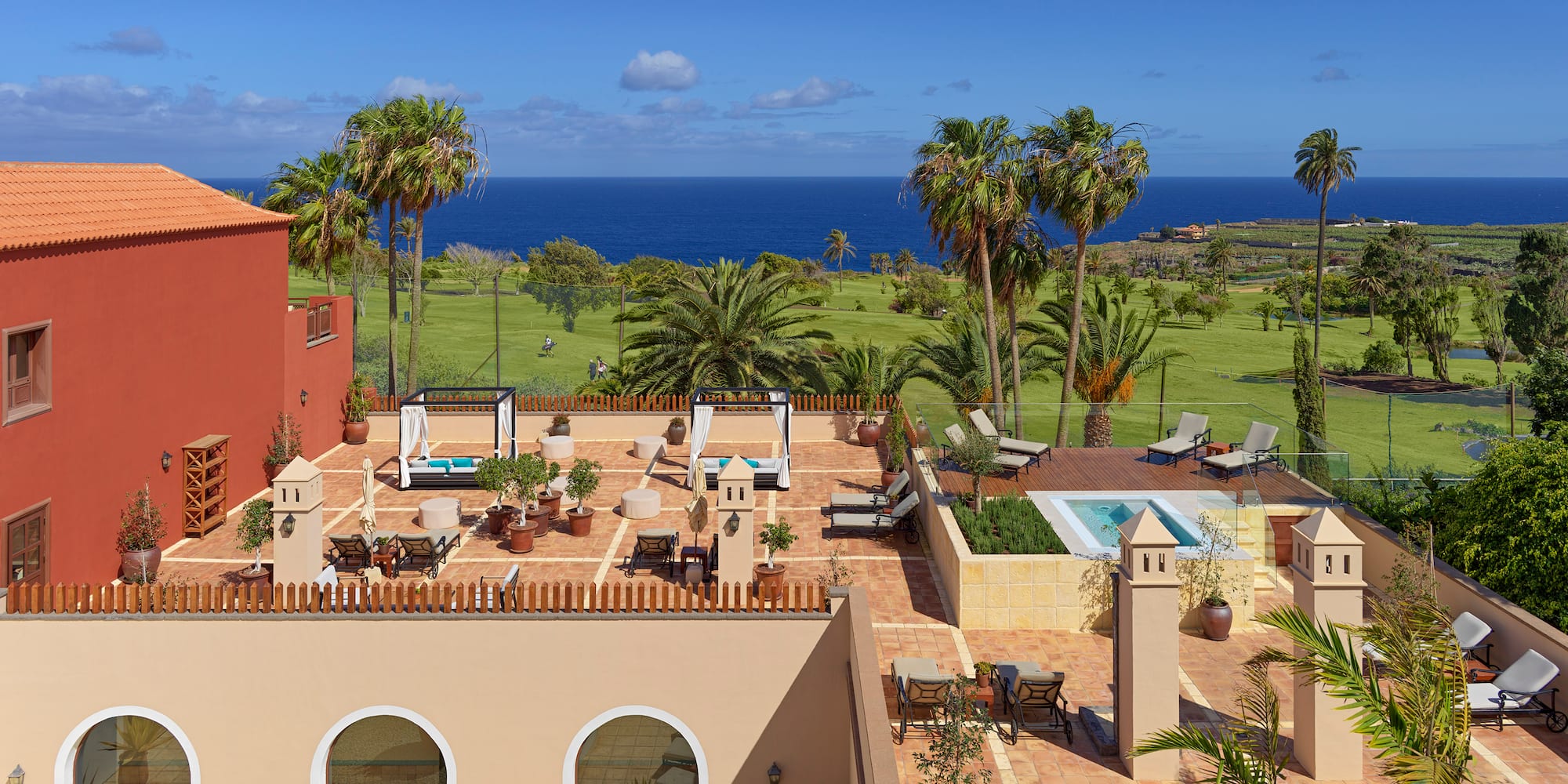 a building with a pool and palm trees