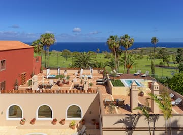 a building with a pool and palm trees