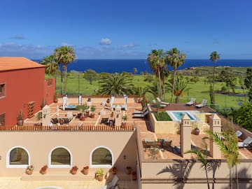 a building with a pool and palm trees