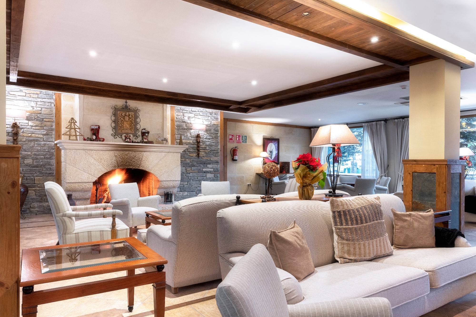 Inviting ski lodge lobby with stone fireplace and comfortable seating.