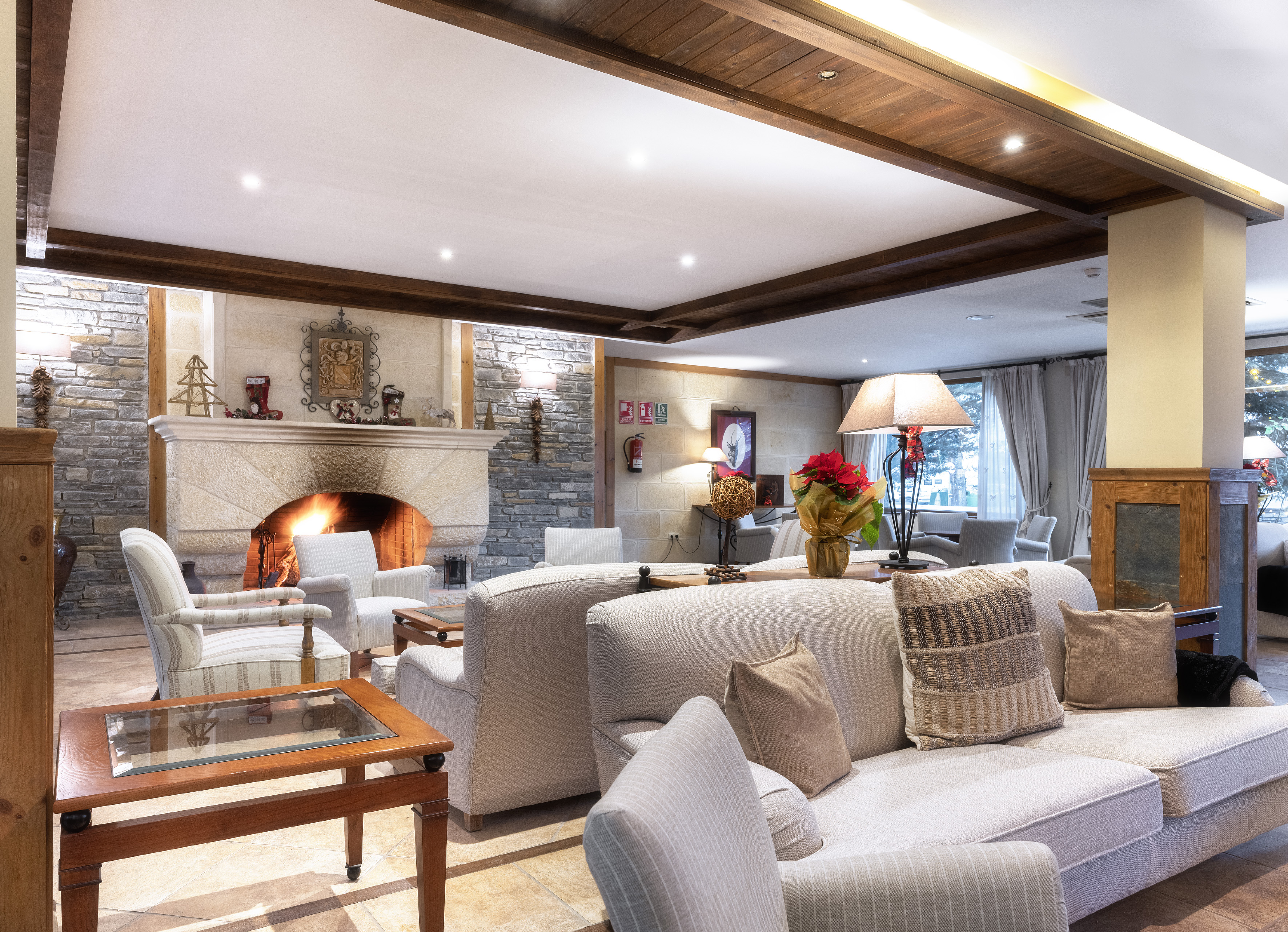 Inviting ski lodge lobby with stone fireplace and comfortable seating.