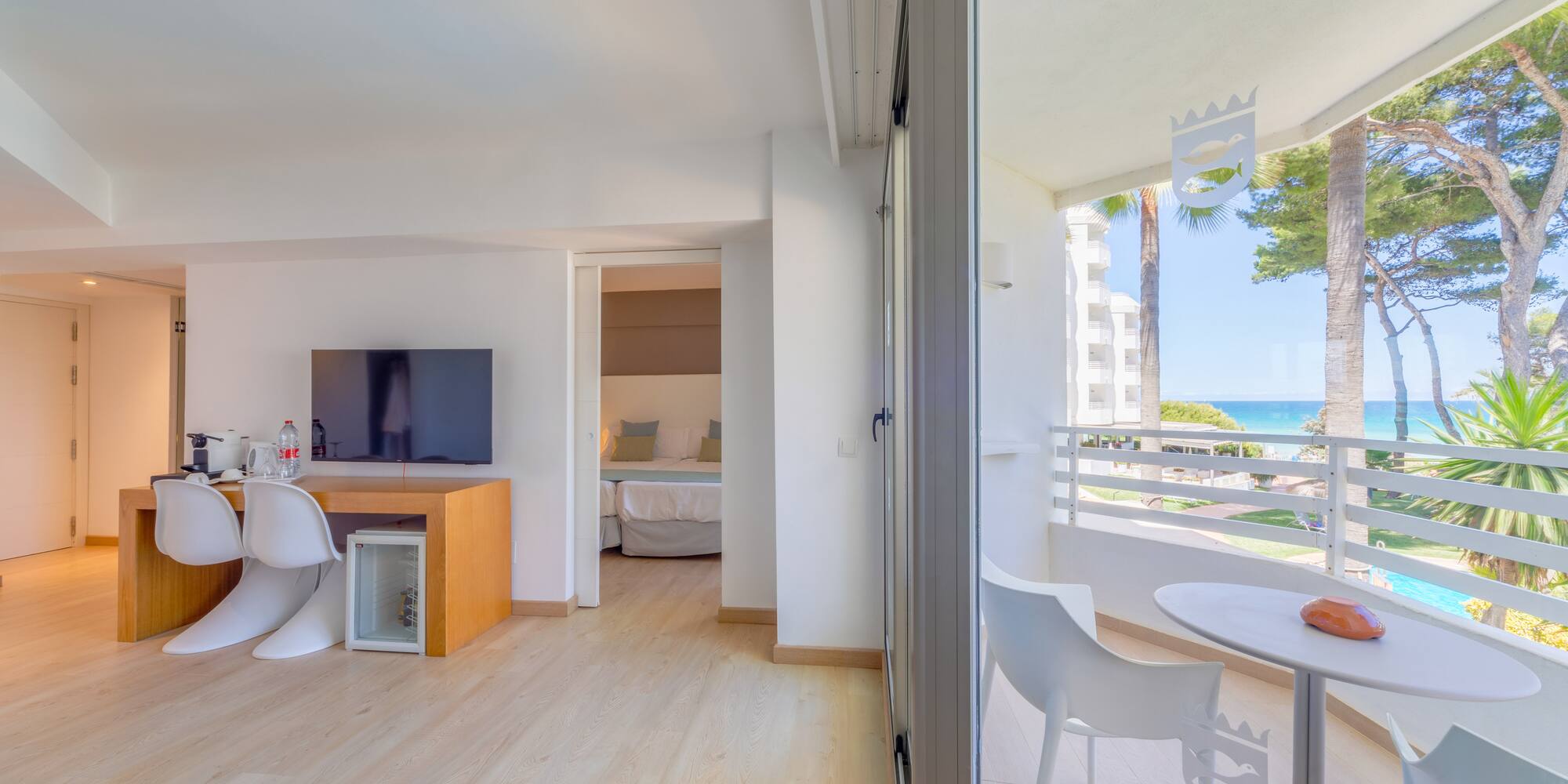 a room with a table and chairs and a television