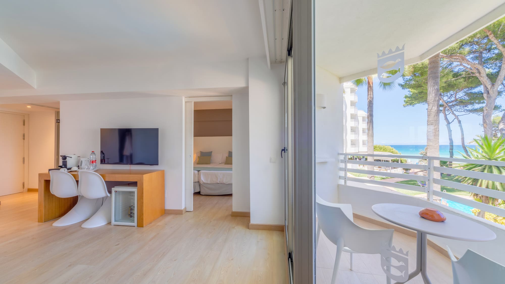 a room with a table and chairs and a television