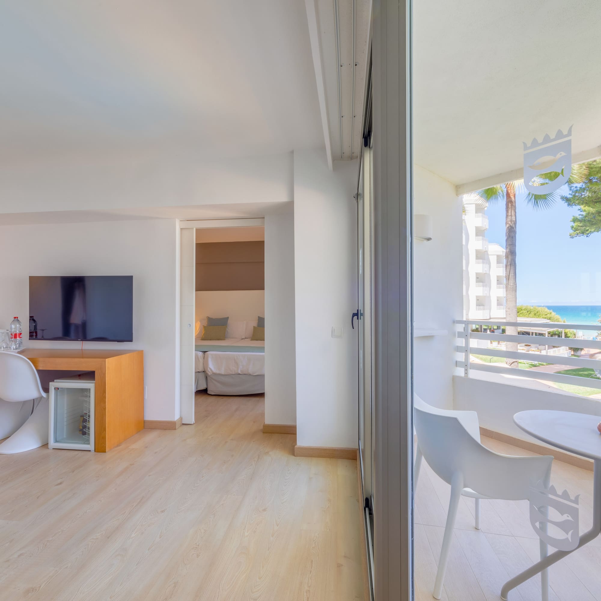 a room with a table and chairs and a television